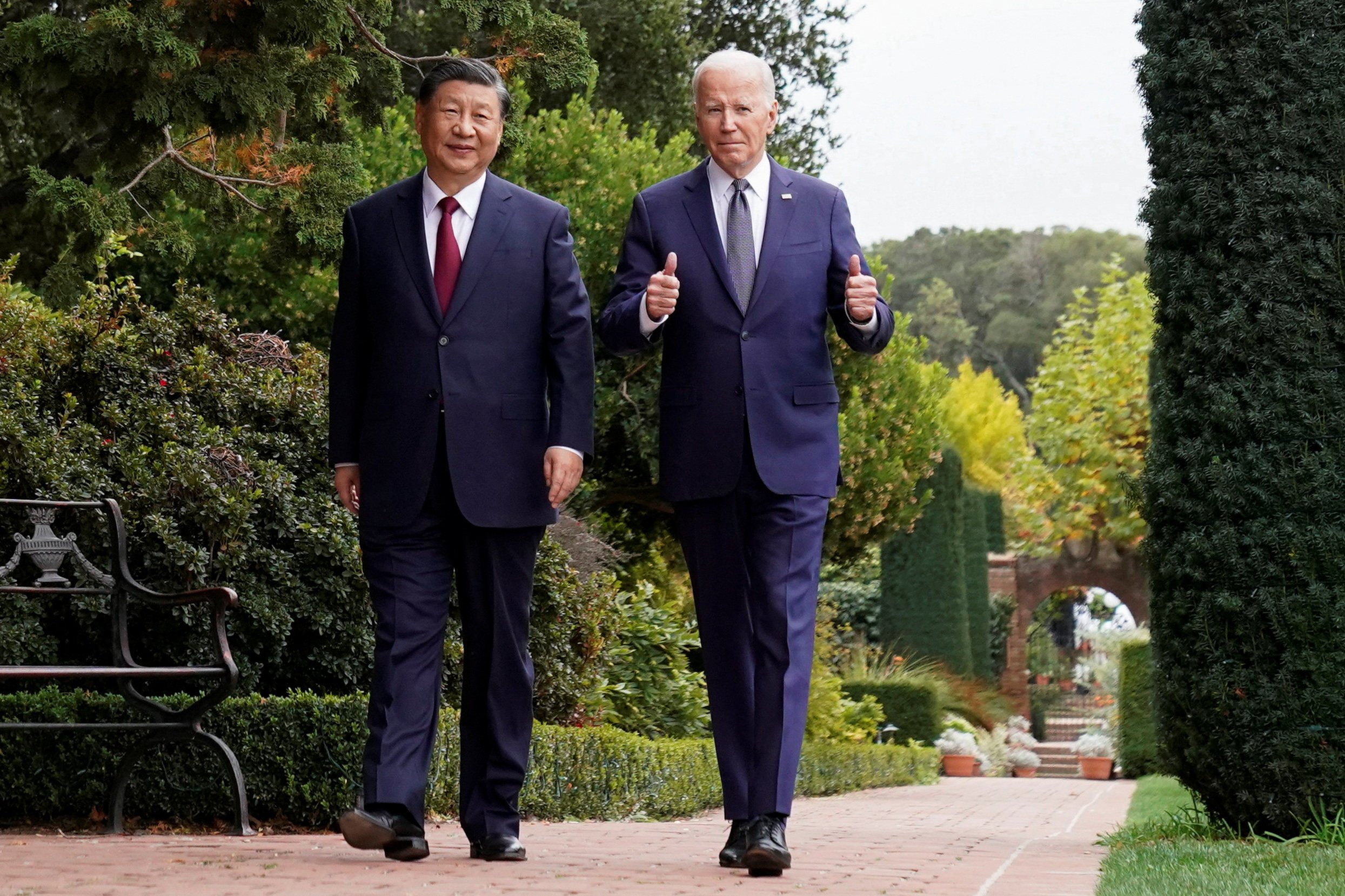 US President Joe Biden gives a thumbs-up as he walks with Chinese President Xi Jinping at Filoli estate on the sidelines of the Apec summit, in Woodside, California, on November 15. Photo: Reuters