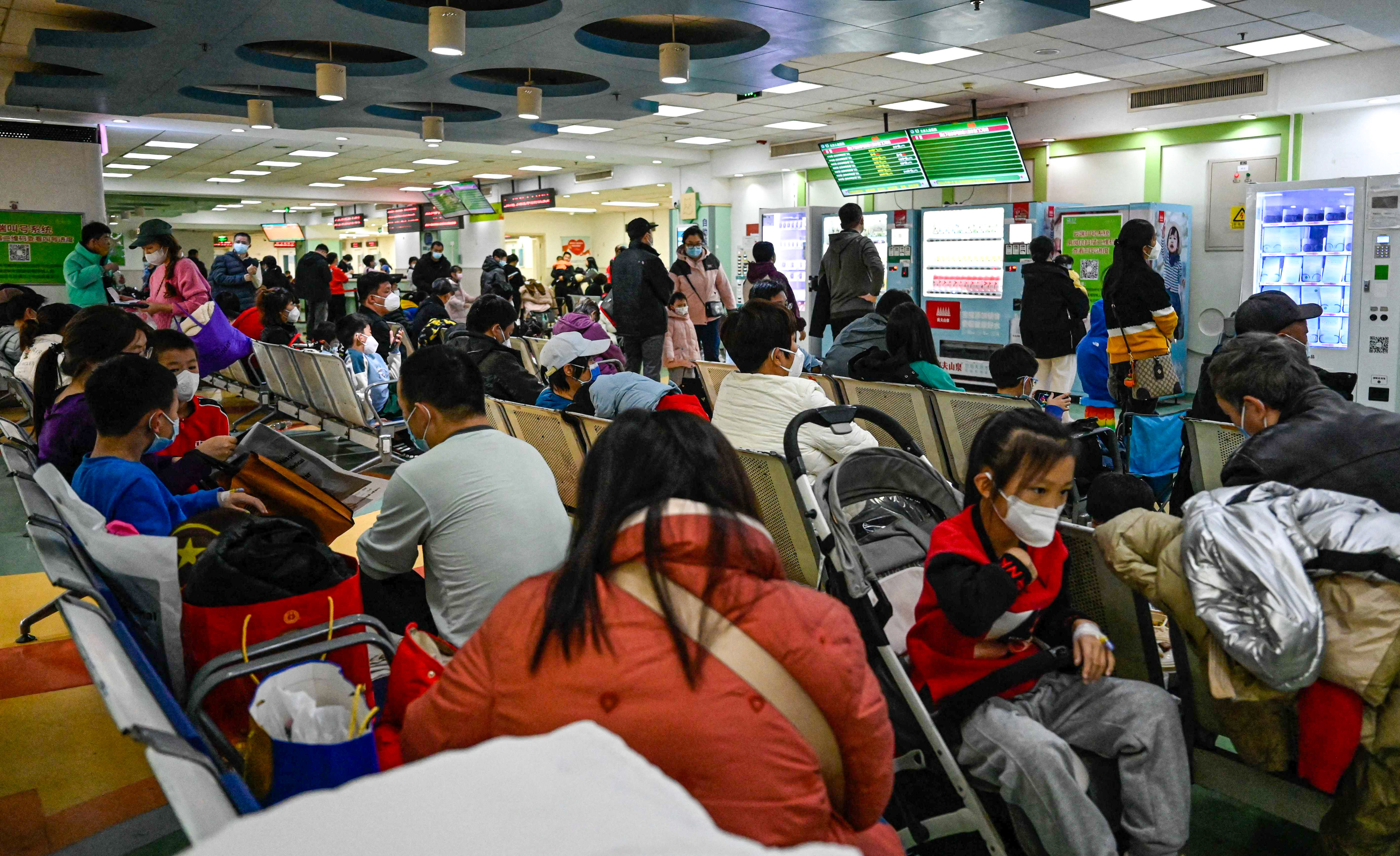 Parents and youngsters wait to be helped in the outpatient area of a Beijing children’s hospital. A spike in respiratory ailments among children in China’s capital city and the northeastern province of Liaoning has raised worries of a wider outbreak involving a new virus. Photo: AFP