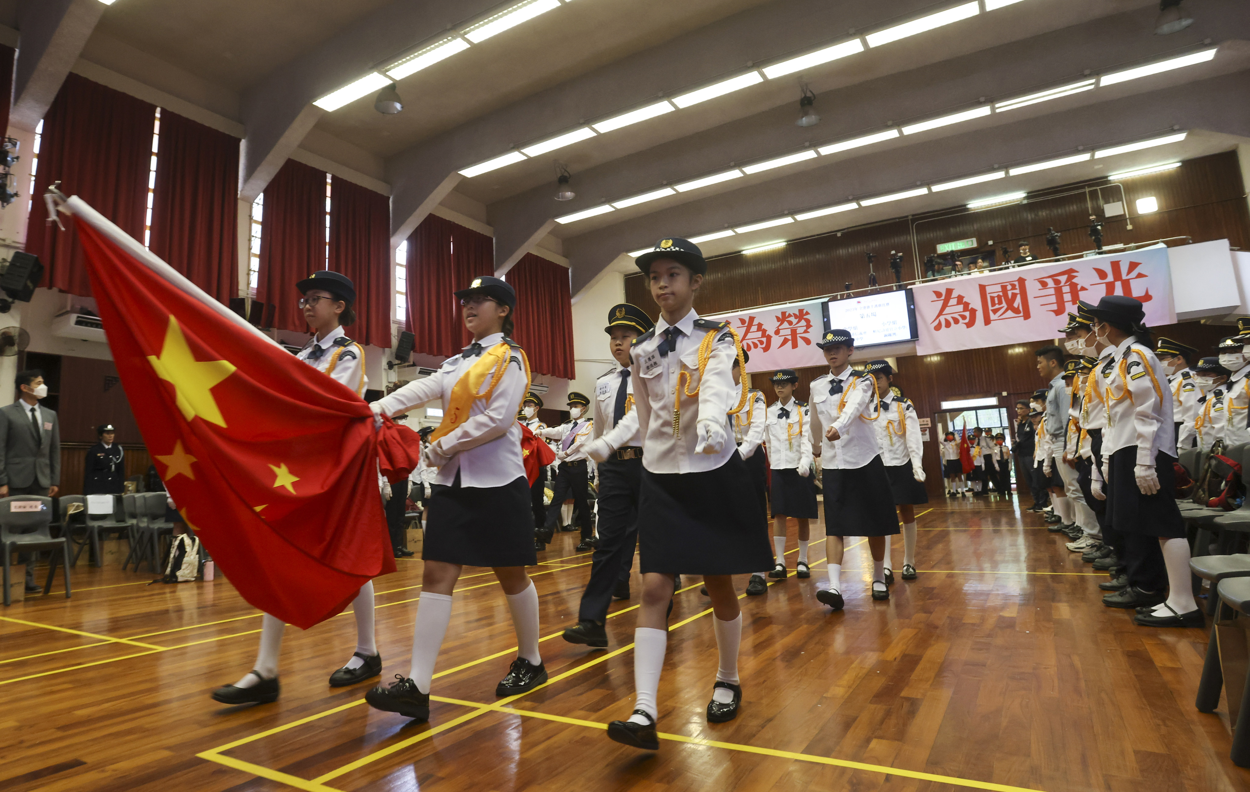 Hong Kong students take part in a flag-bearing competition in May. Patriotic values aside, Hong Kong should not overlook the importance of whole-person education. Photo: Jonathan Wong