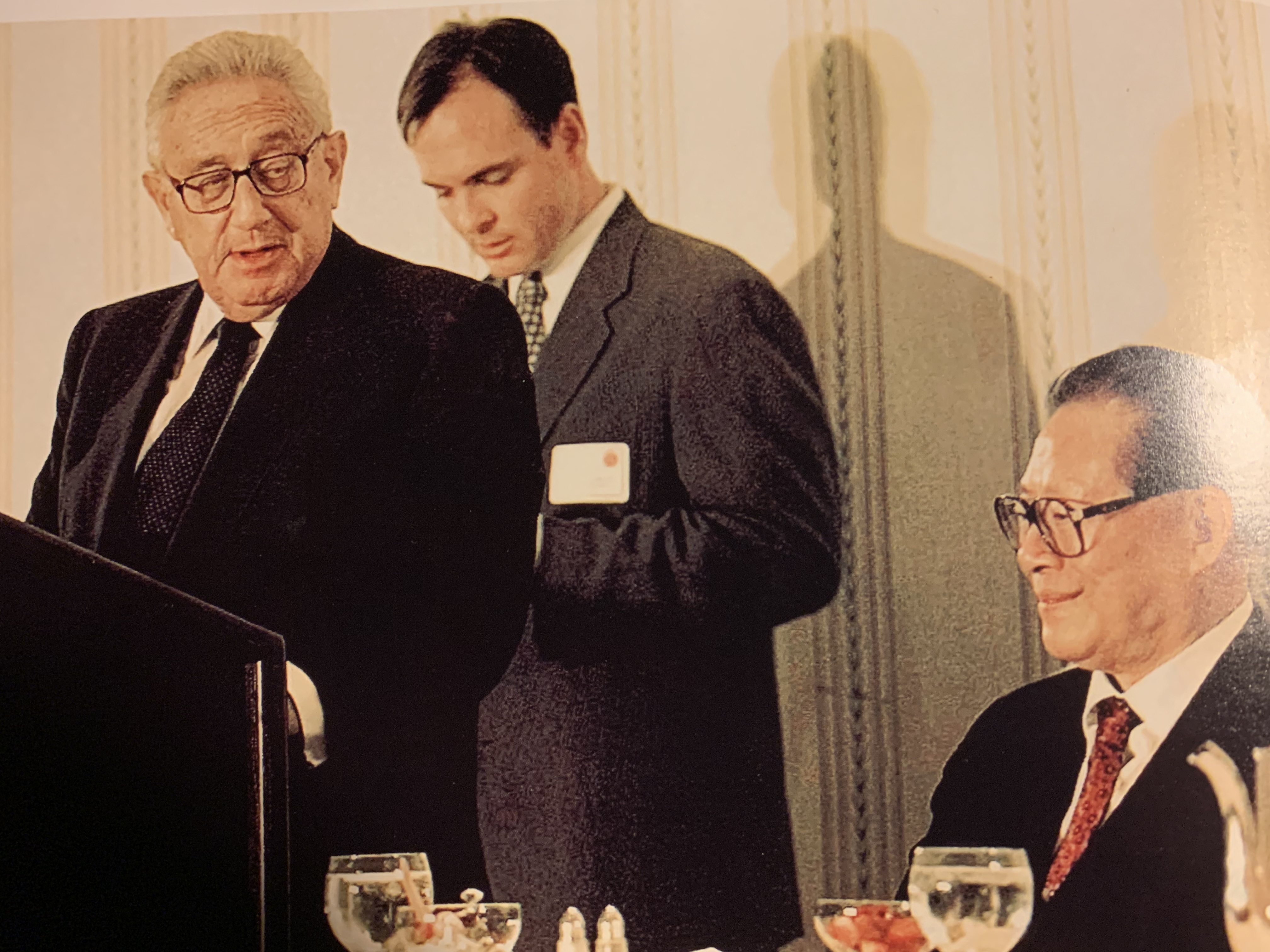 Robert Daly, pictured interpreting for Henry Kissinger and Jiang Zemin in 1997, said Kissinger was “one of the last giants”. Photo: Supplied by Robert Daly