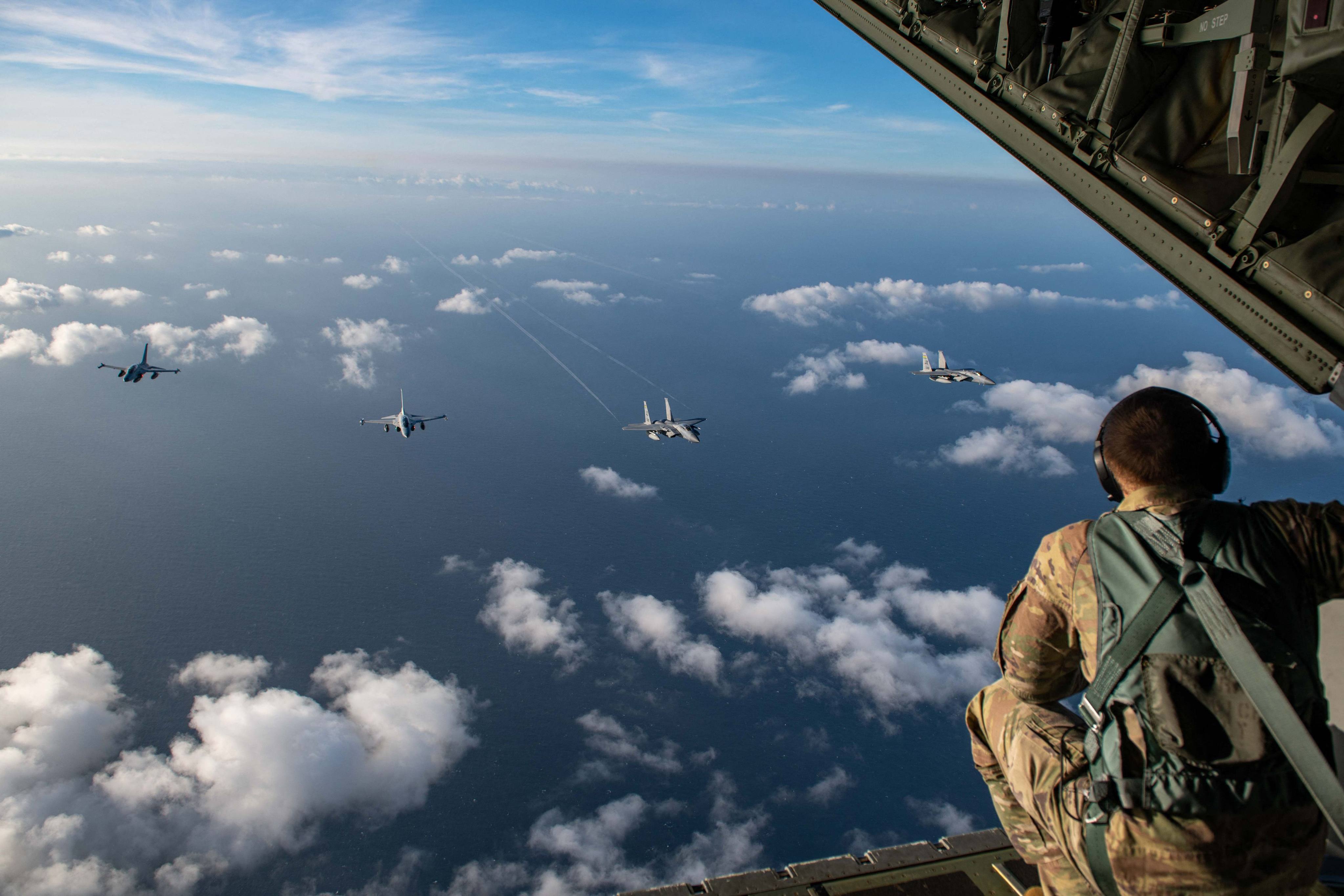 A US serviceman watches two Philippine Air Force FA-50s fly alongside two US Air Force F-15C Eagles over the South China Sea during the countries’ joint maritime and air patrols on Nov. 21. Photo: US Air Force/AFP