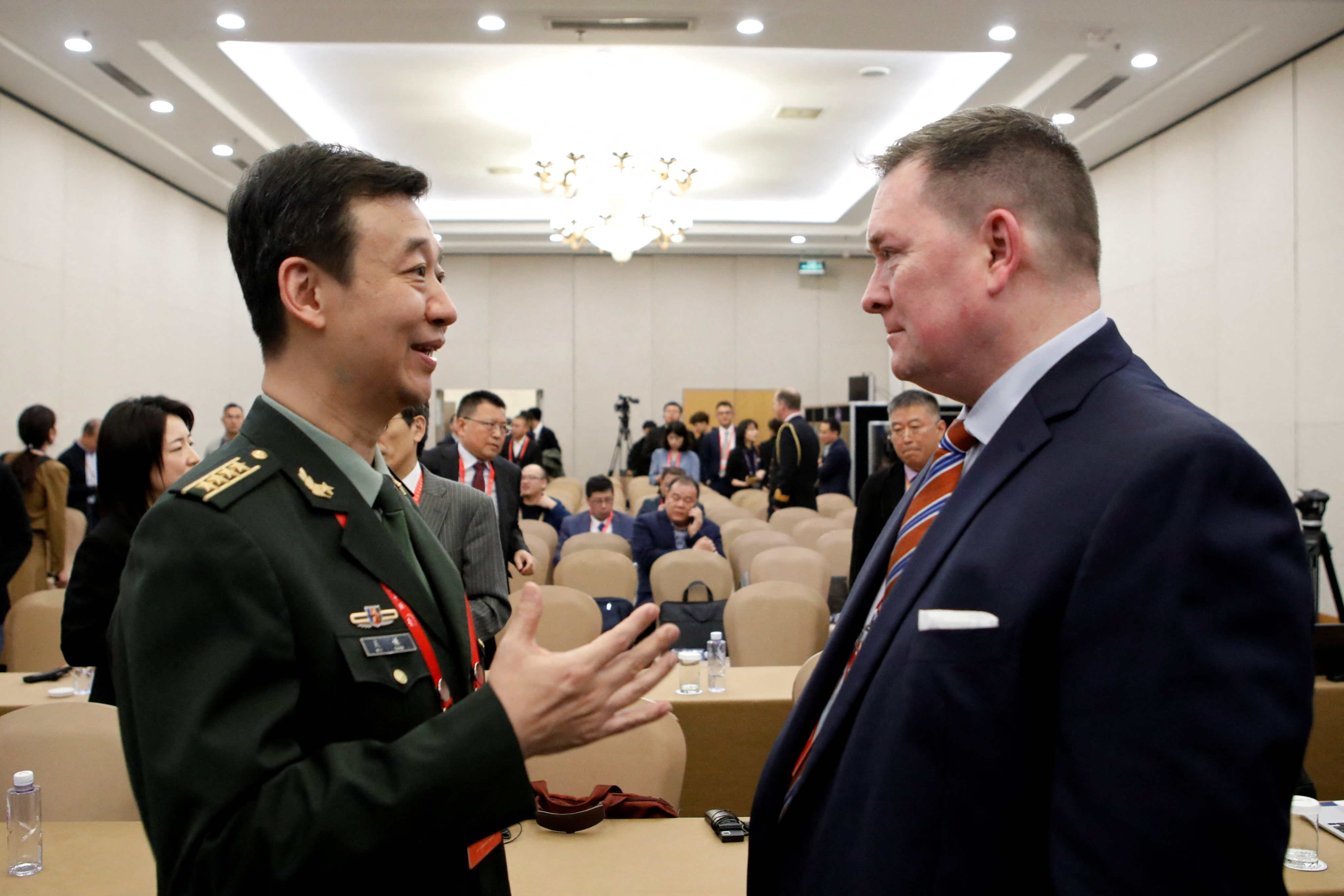 Chinese Defence Ministry spokesman Senior Colonel Wu Qian (left) speaks with former Pentagon official Chad Sbragia at the Xiangshan Forum in Beijing on October 30. Photo: Reuters