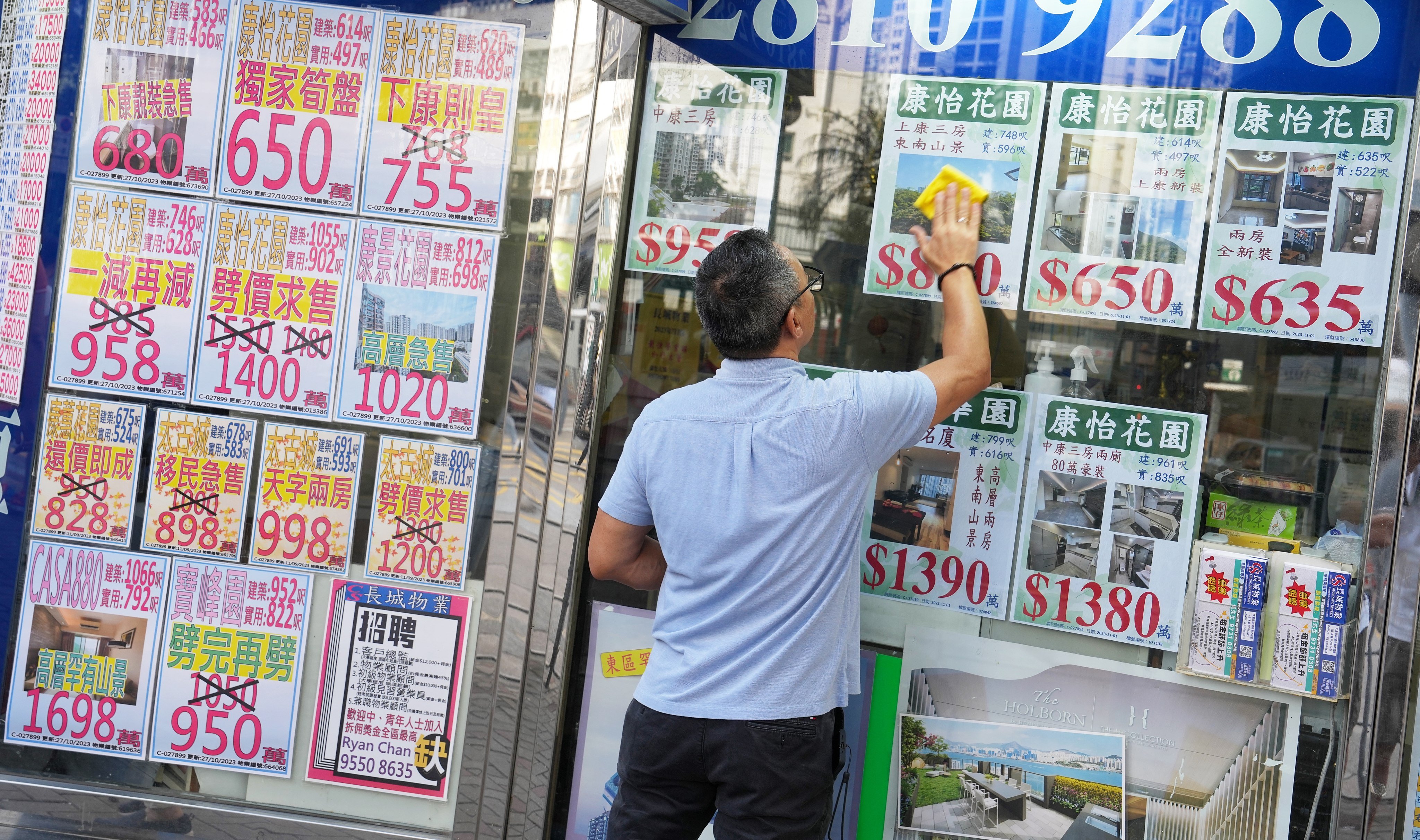 Property listings are displayed on the window of a real estate agency in Quarry Bay. Photo: Elson Li