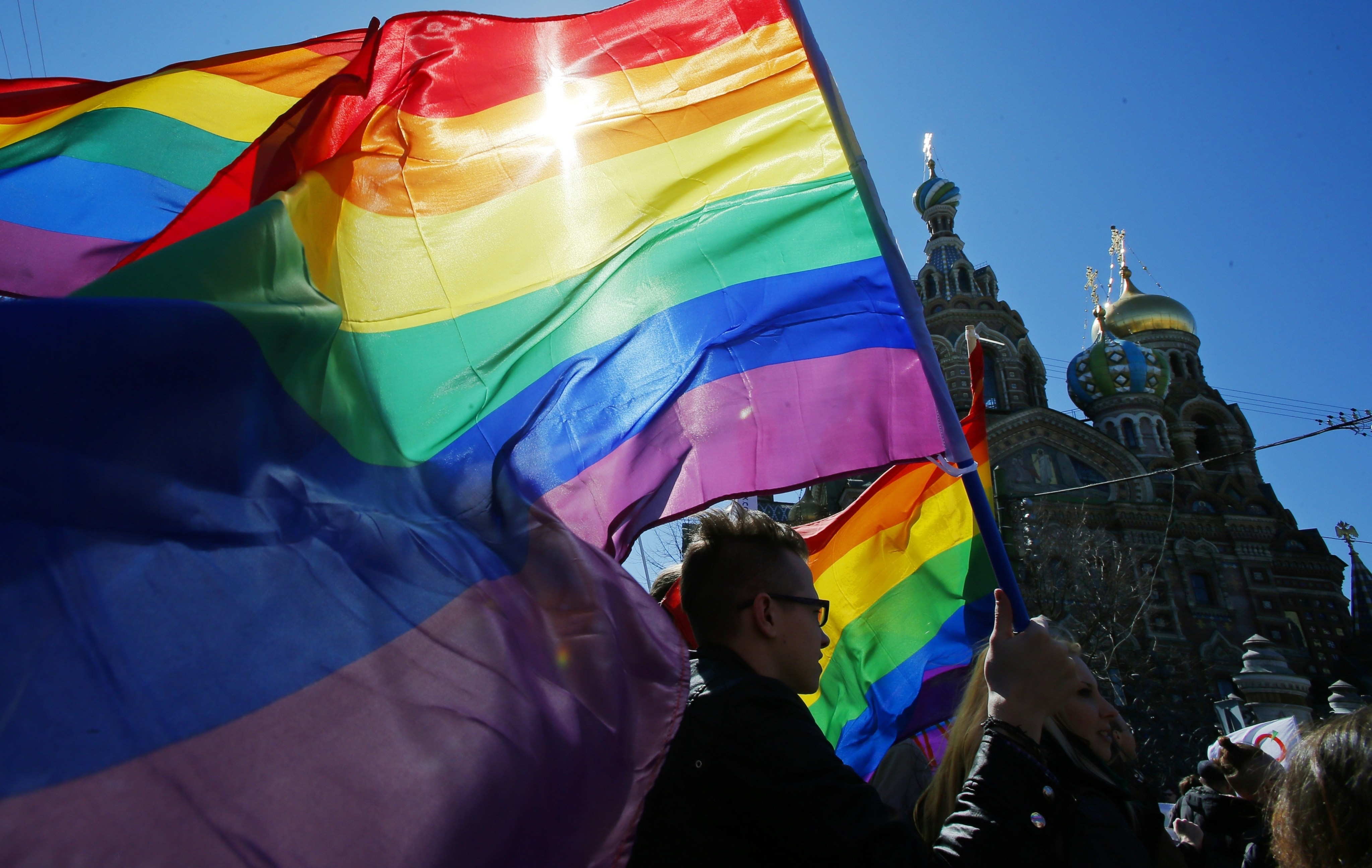 Gay rights activists carry rainbow flags as they march in St Petersburg, Russia in May 2013. Photo: AP