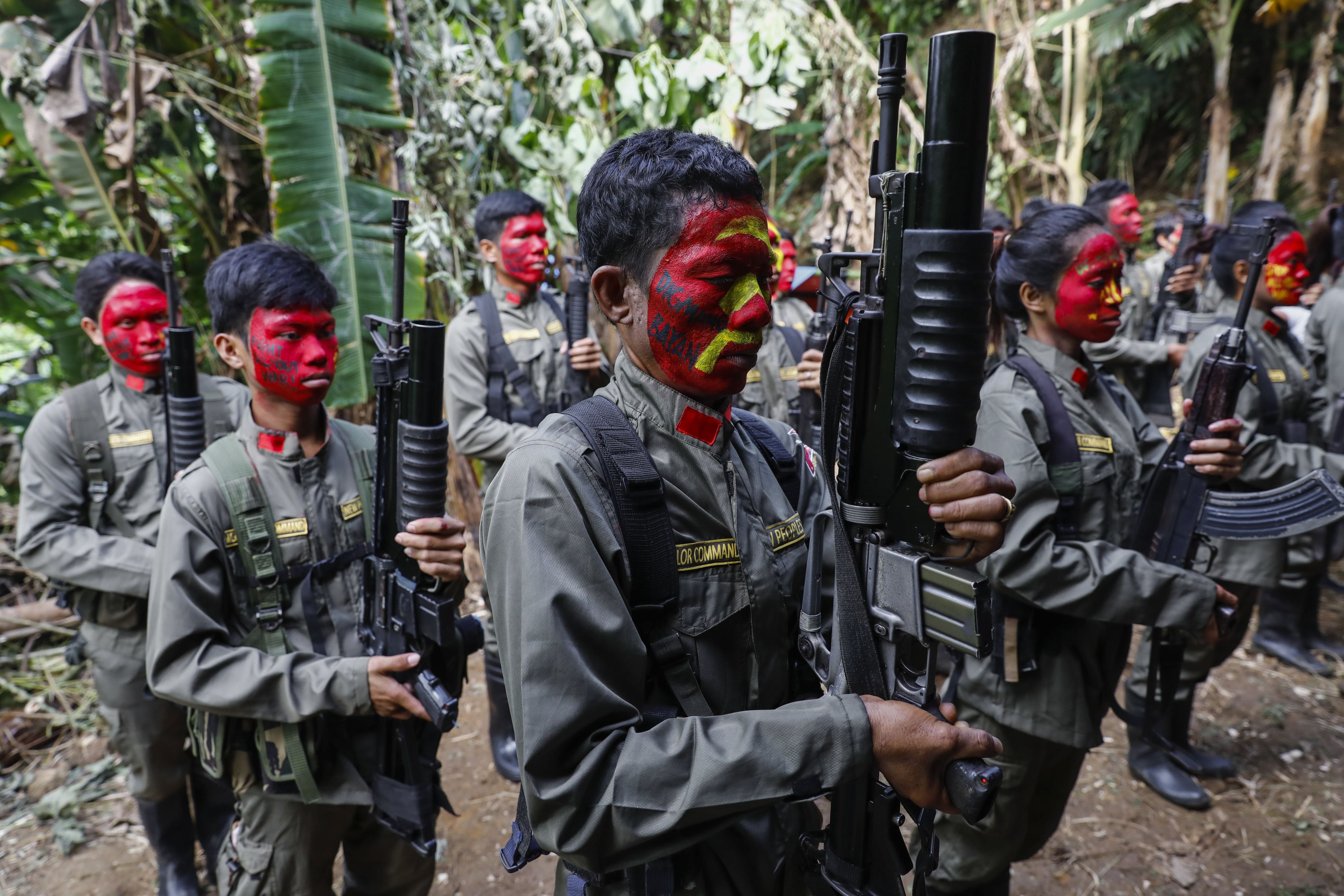 Fighters of the New People’s Army, the armed wing of the Philippine Communist Party, in formation in the Sierra Madre mountains of Luzon region on July 20, 2017. Photo: EPA