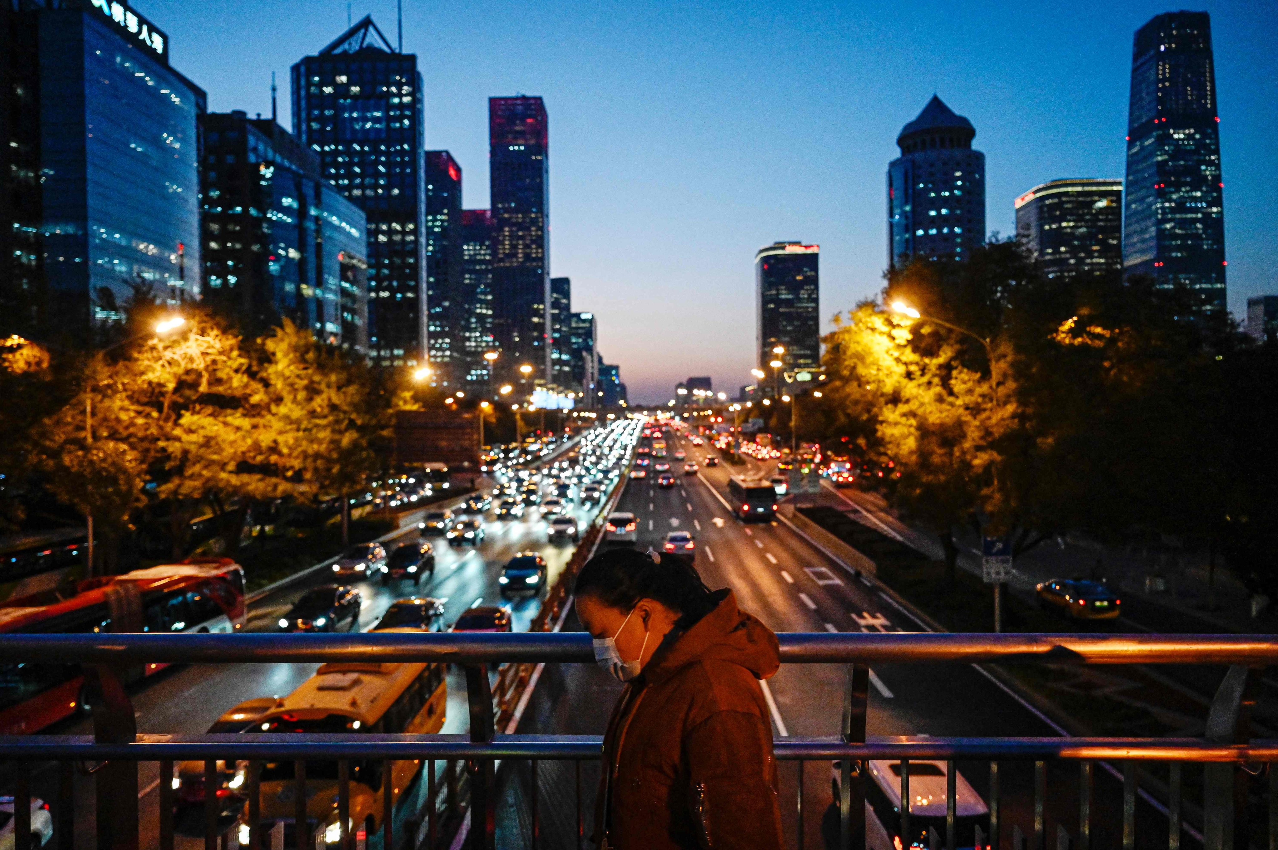 A woman walks on an overpass in Beijing’s central business district on November 14. Tyres shed trillions of toxic microparticles, making up at least 10 per cent of the microplastics in the ocean, and small enough to interact with our cells, causing increasing concern to health scientists and environmentalists. Photo: AFP
