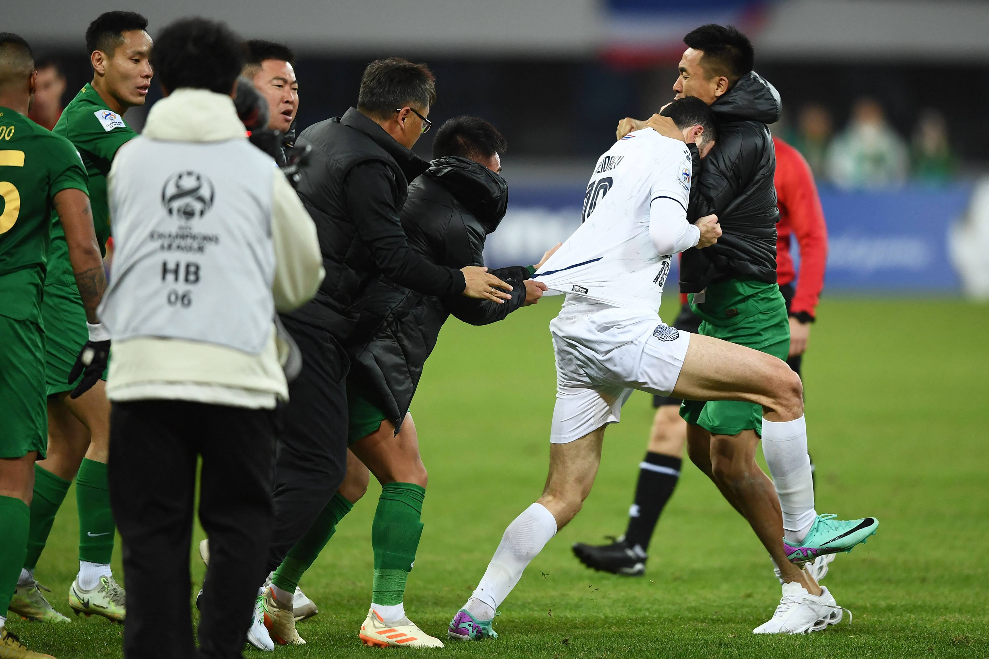 Buriram United’s Ramil Sheydayev (left in white) attacked members of China’s Zhejiang FC during a brawl. Photo: AFP