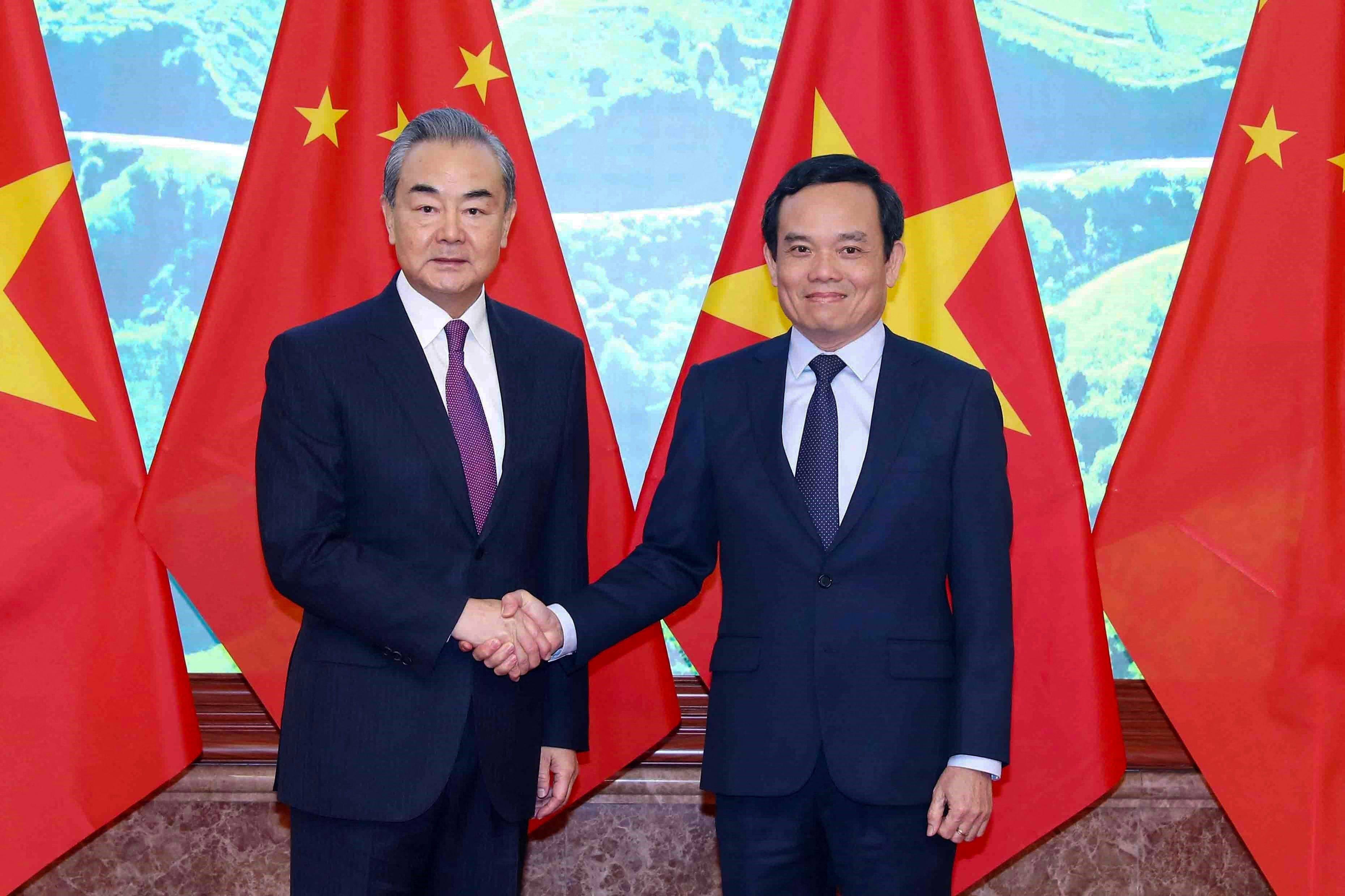 Chinese Foreign Minister Wang Yi (left) meets Vietnamese deputy prime minister Tran Luu Quang in Hanoi on Friday. Photo: Vietnam News Agency via AFP