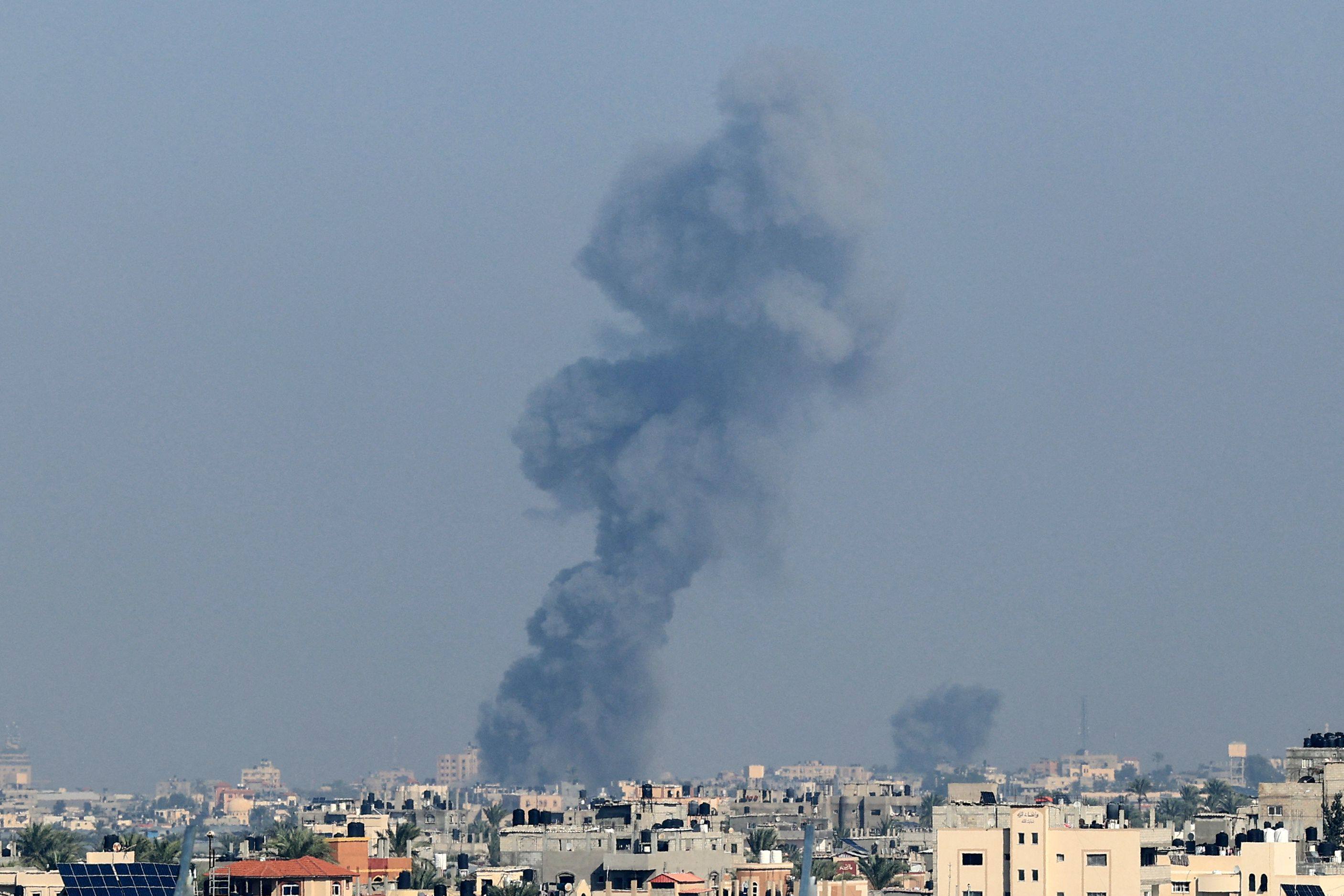 Smoke rises above buildings during Israeli strikes on Khan Yunis in the southern Gaza Strip, after battles resumed between Israel and Hamas militants, on Saturday. Photo: AFP