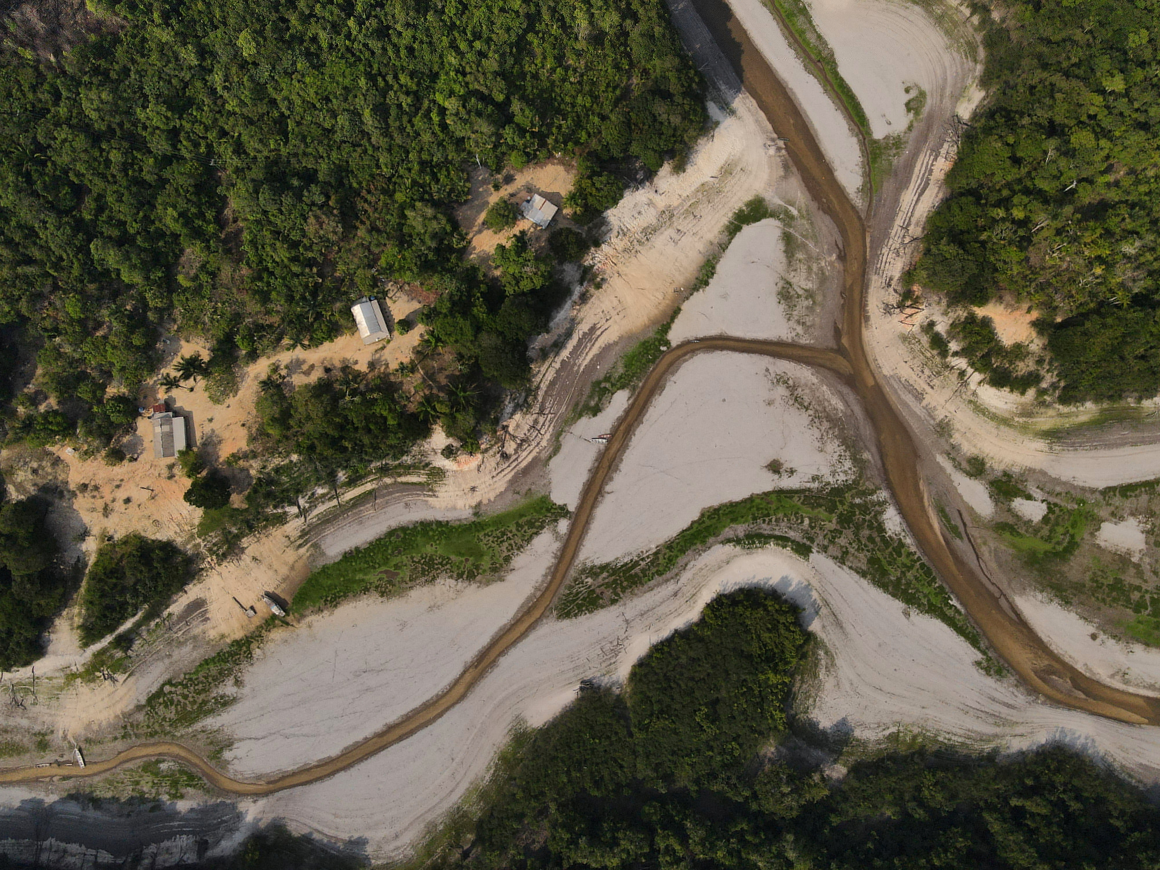 An aerial view of a riverside community, next to a dry area of the Igarape do Jaraqui stream, an affluent of Rio Negro river, part of the Puranga Conquista Sustainable Development Reserve in Manaus, Brazil, on November 1. Photo: Reuters