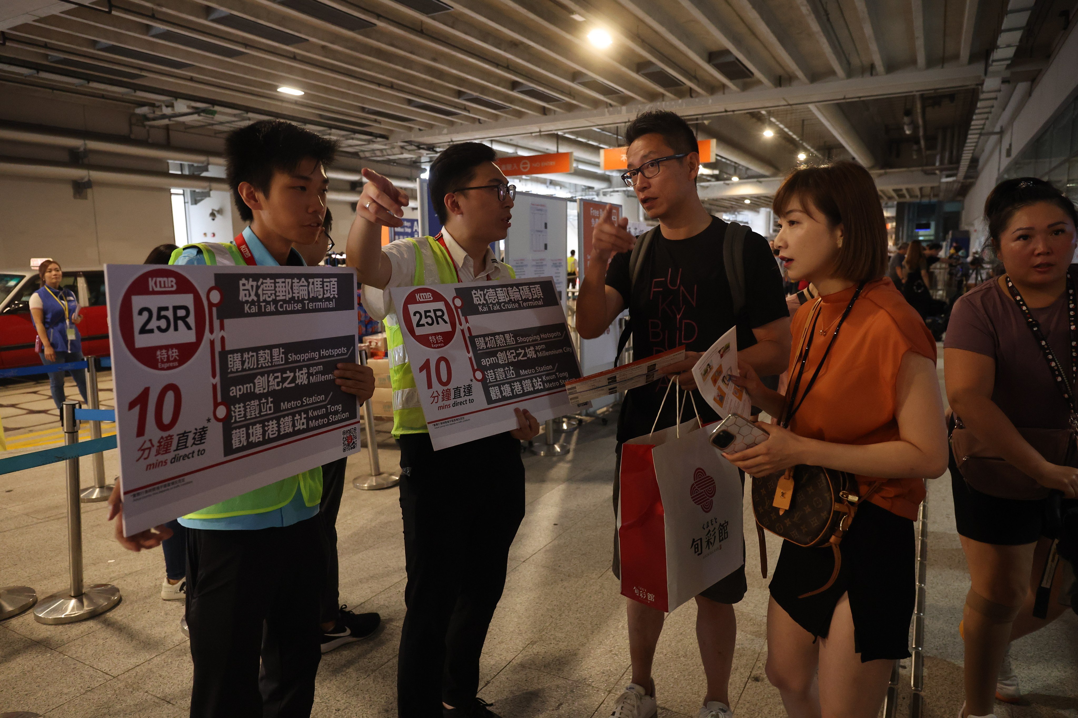 KMB Bus staff give directions to arriving passengers from the cruise ship “Spectrum of the Sea” at Kai Tak Cruise Terminal on August 19. Photo: Edmond So