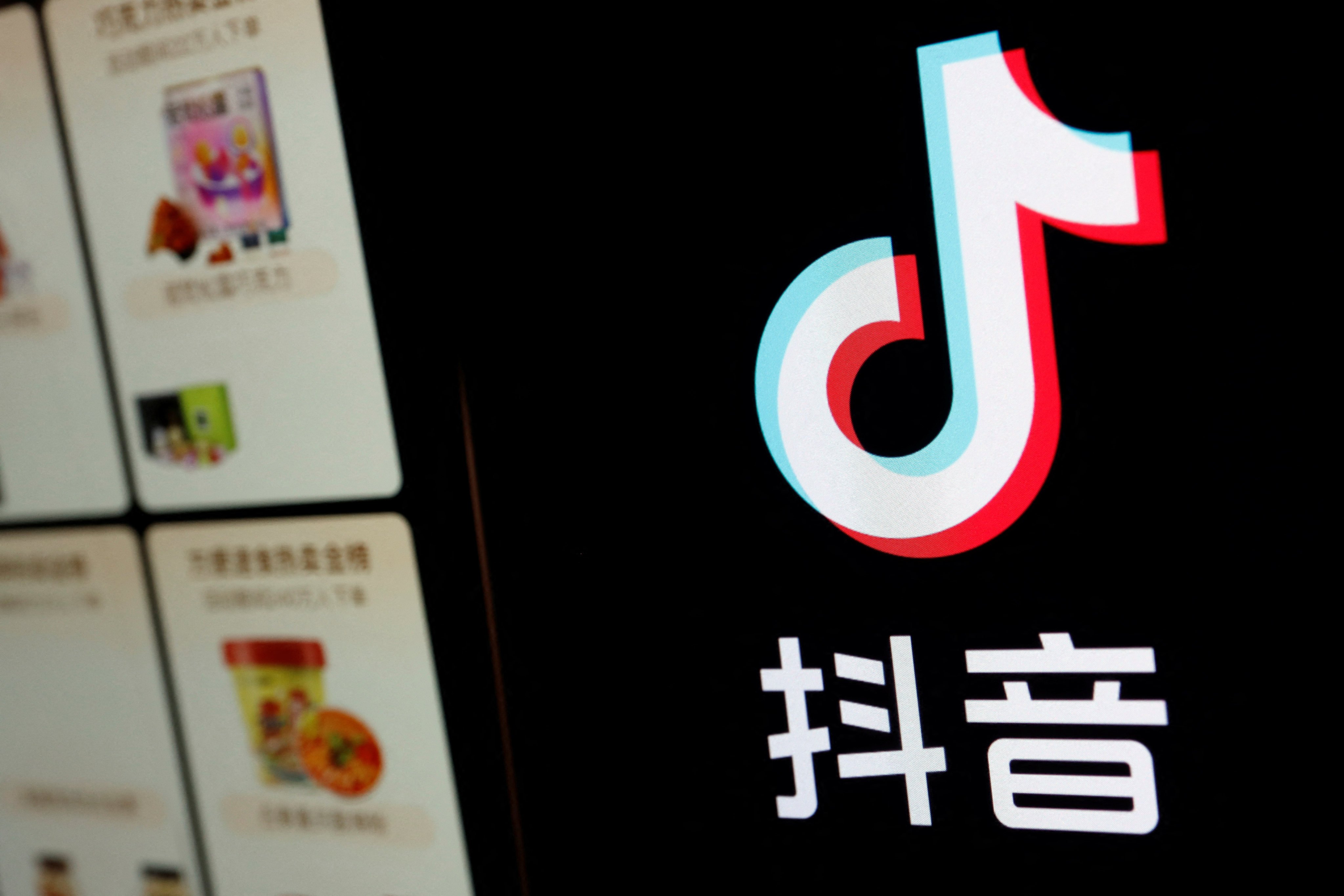 The logo of Douyin is displayed next to a mobile phone displaying an e-commerce site on the app. Photo: Reuters