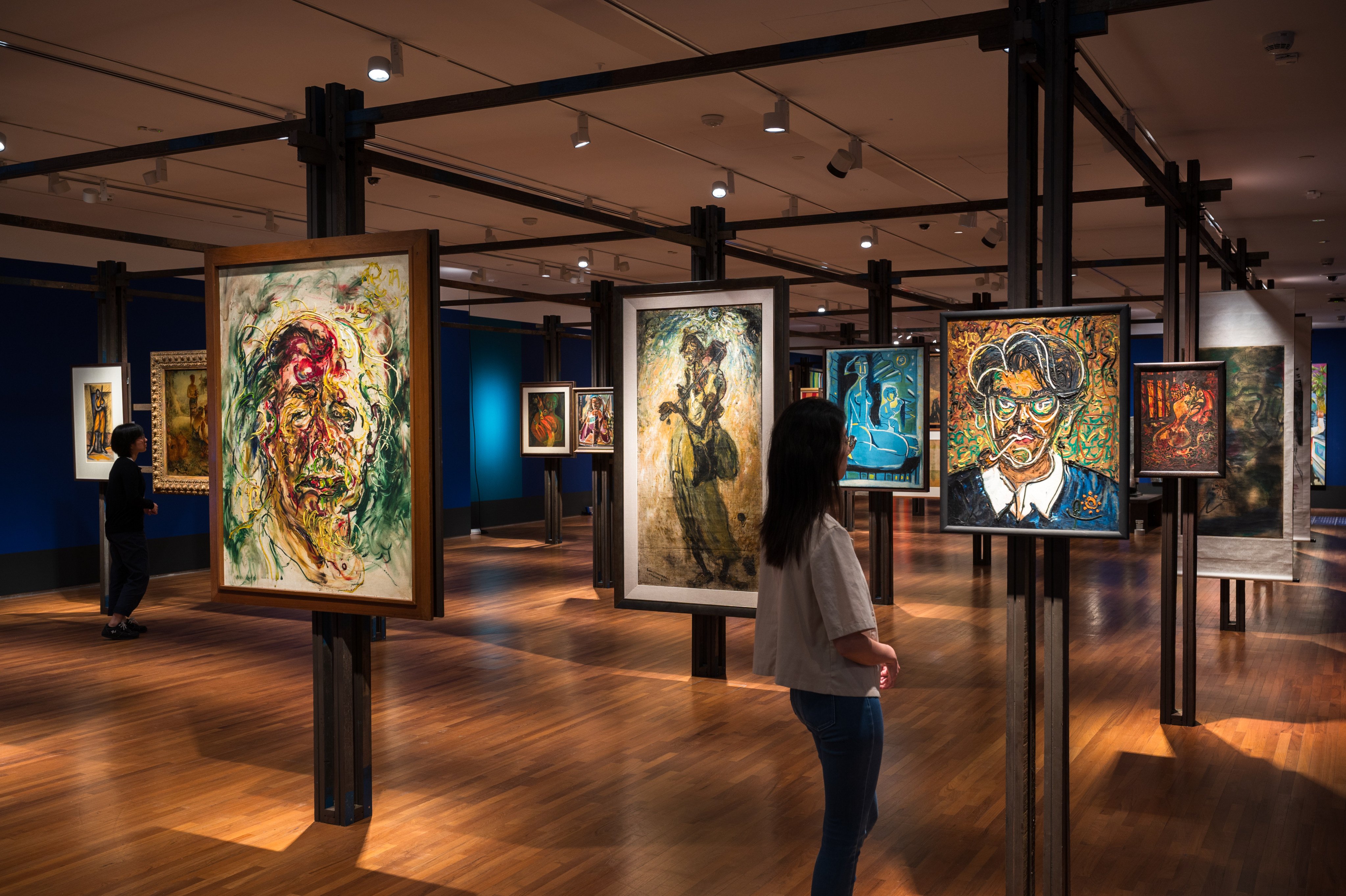 A visitor looks at paintings at the National Gallery Singapore’s “Tropical” exhibition, which explores colonial and postcolonial experiences in Southeast Asia and Latin America and features artists including Paul Gaugain, Frida Kahlo and David Medalla. Photo: National Gallery Singapore