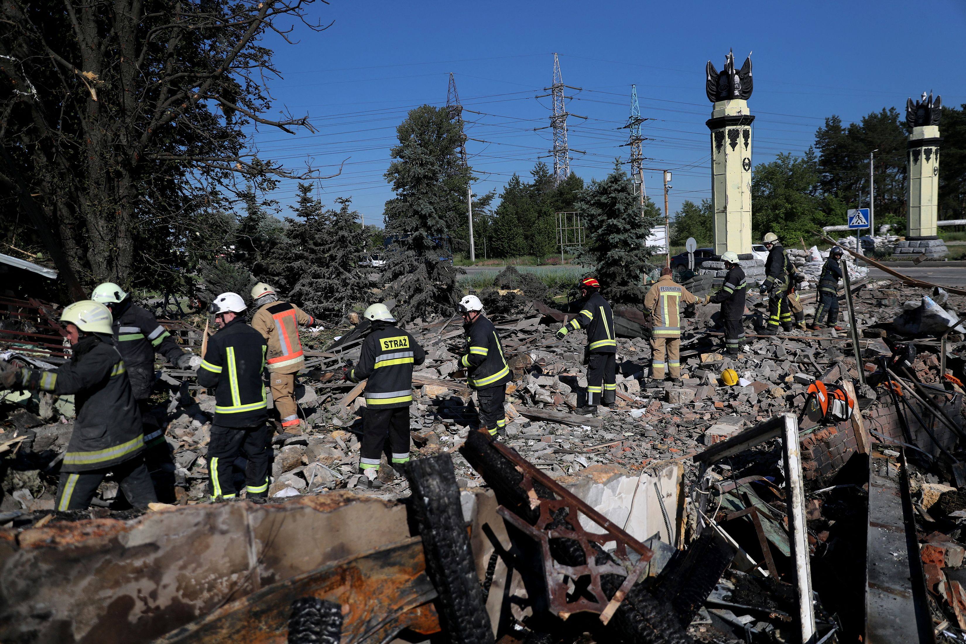Firefighters remove debris searching a casualty following a military strike amid Russia’s attack on Ukraine. Photo: Reuters