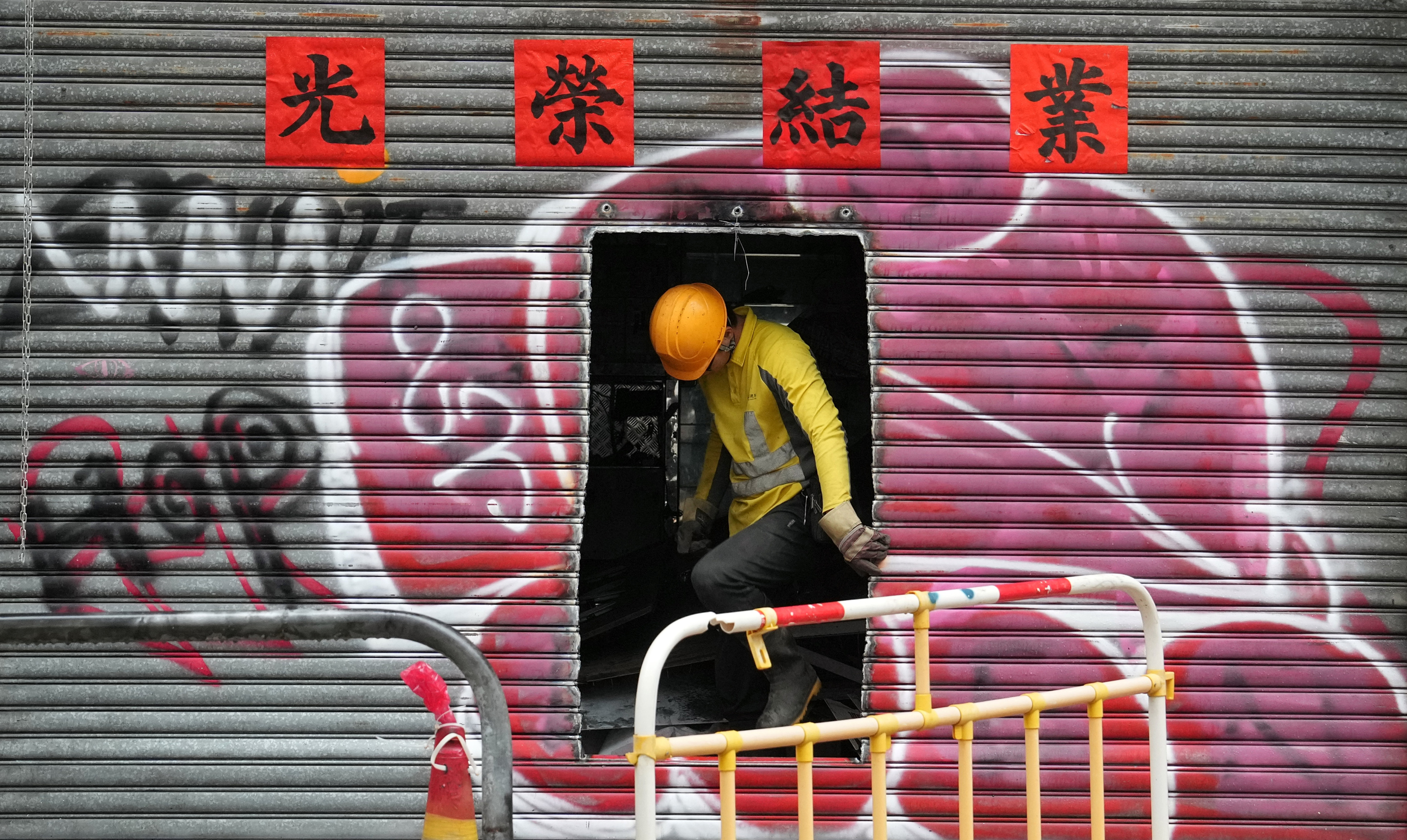 A worker cleans up a shop which has gone out of business in Wan Chai on October 18.  High street shop rents in core districts grew 2.4 per cent in the third quarter, but the recovery of the retail sector still has some way to go. Photo: Elson Li