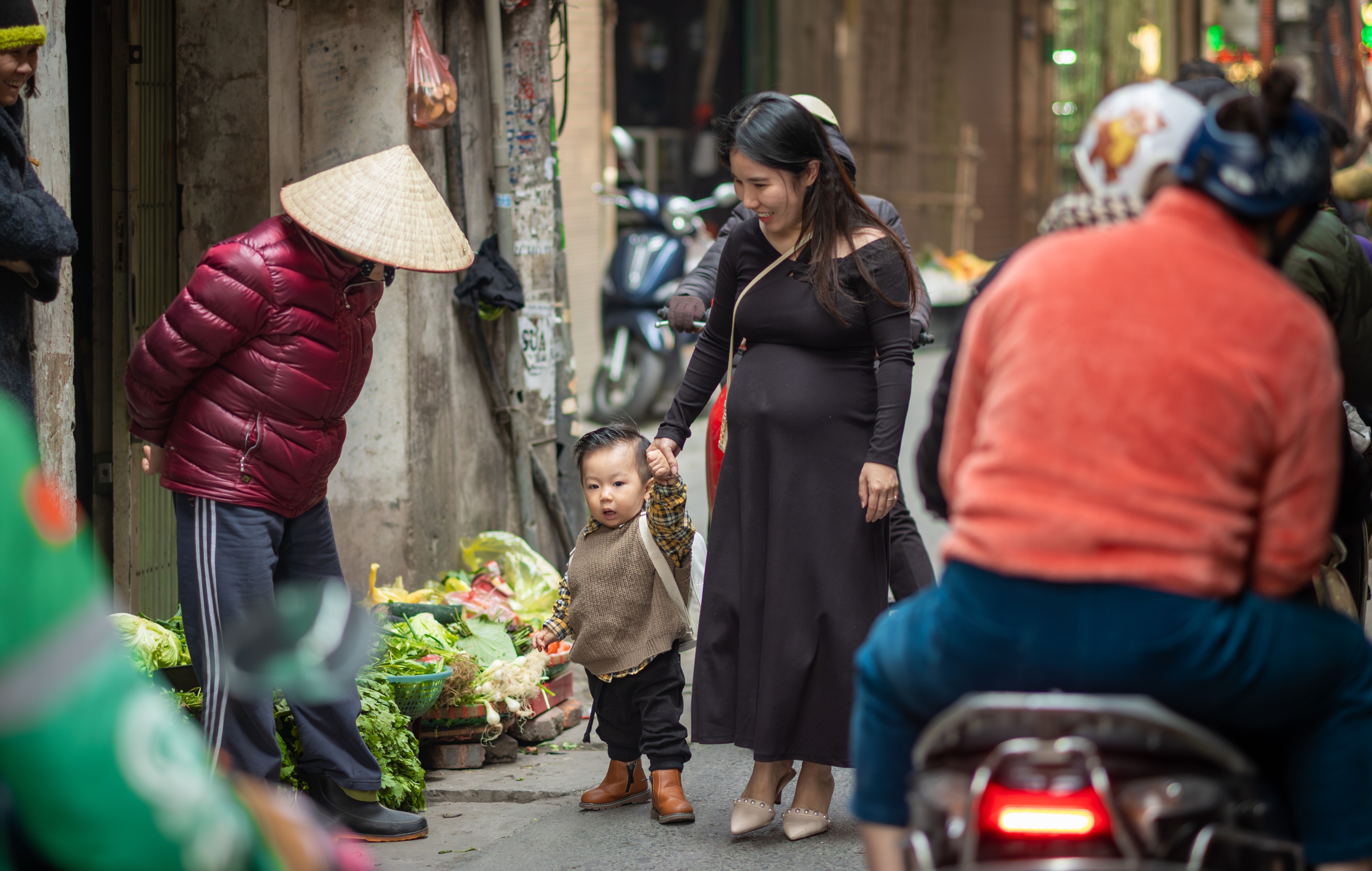 A pregnant woman walks with her young son in Hanoi. Vietnamese culture is still influenced by Confucianism and couples still tend to hope for sons. Photo: Shutterstock