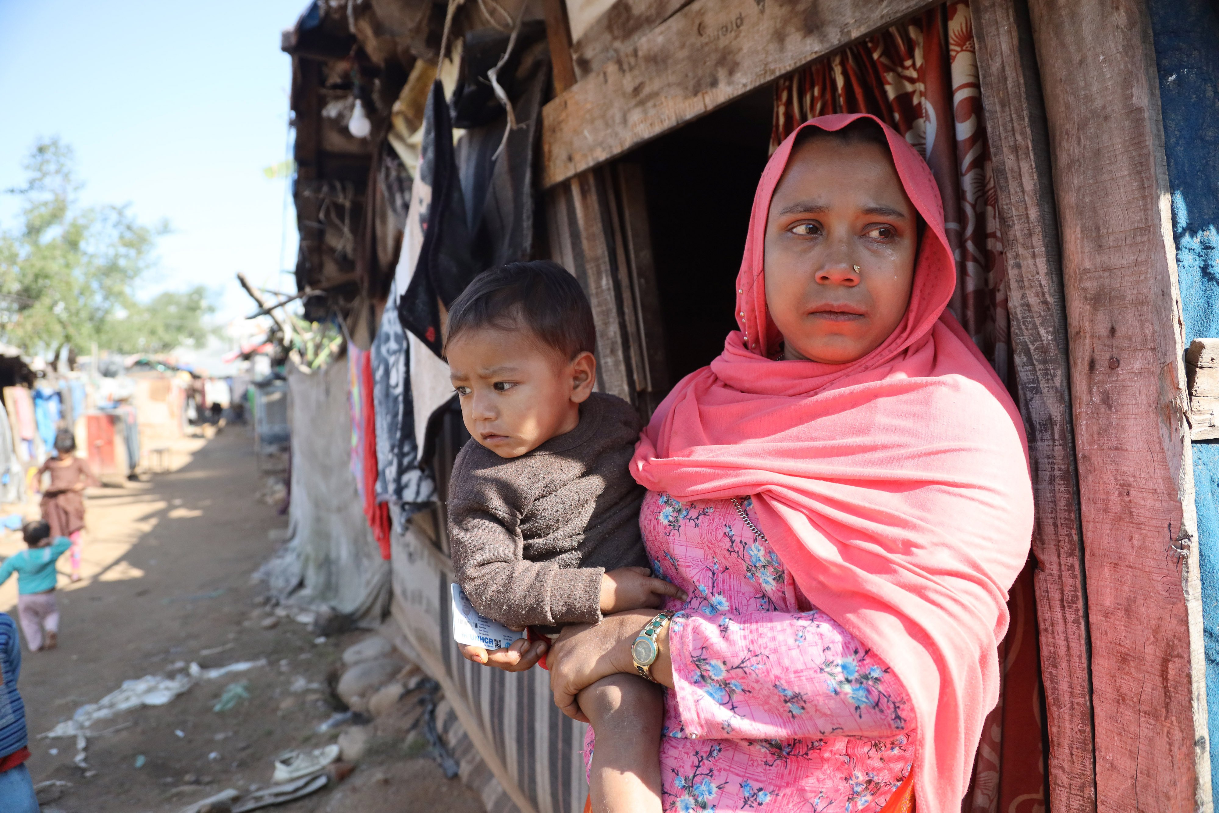 Noor Jahan holds her one-year-old baby in the Narwal area of Jammu, where she lives with her husband in a rented shanty. Photo: Kamran Yousuf