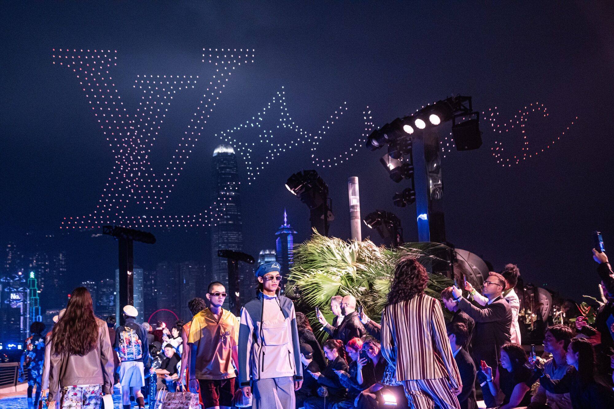 Drones display Louis Vuitton’s logo during the brand’s invitation-only fashion show held on the Avenue of Stars in Hong Kong on November 30. Accessible luxury retailers are having to contend with shifts in local consumption patterns, as well as exclusivity strategies by luxury brands. Photo: Bloomberg 