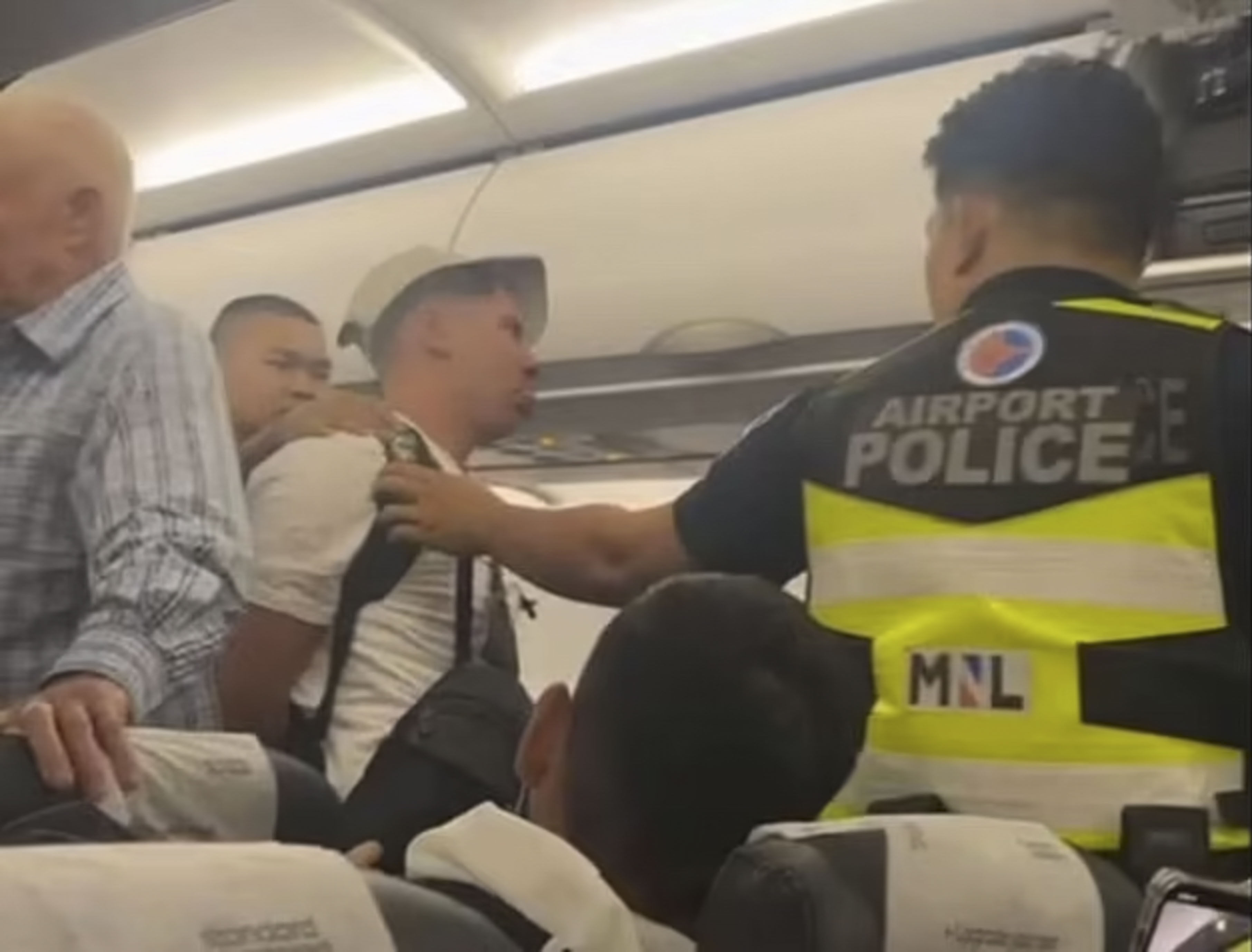 A passenger on board a Scoot flight headed from Singapore to Manila had to be restrained and escorted off the aircraft. Photo: Reddit