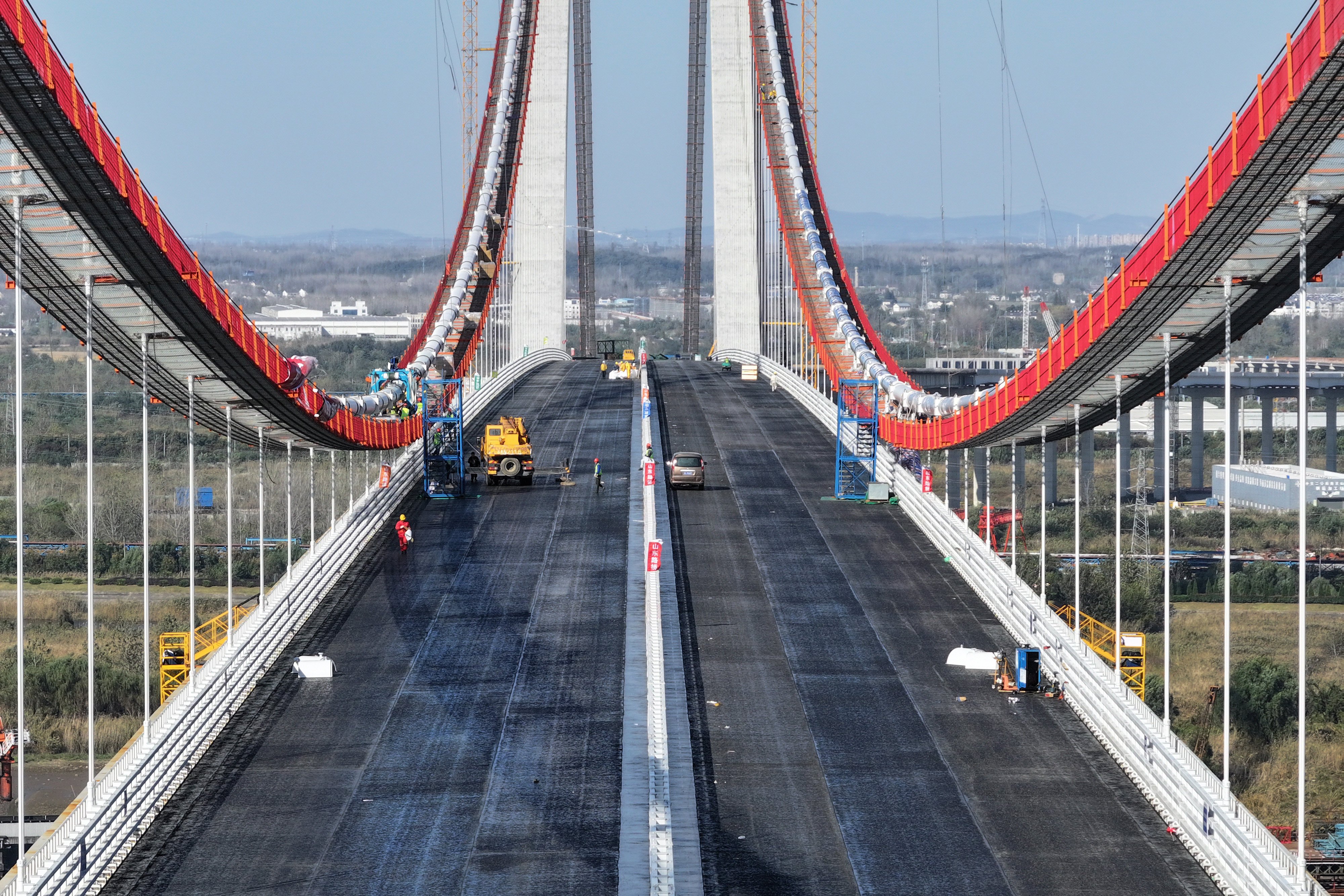 Workers work on the steel deck of the main bridge of the Xianxin Road Yangtze River Bridge in Nanjing, in China’s eastern Jiangsu province, in this file photo from November. Photo: Getty Images