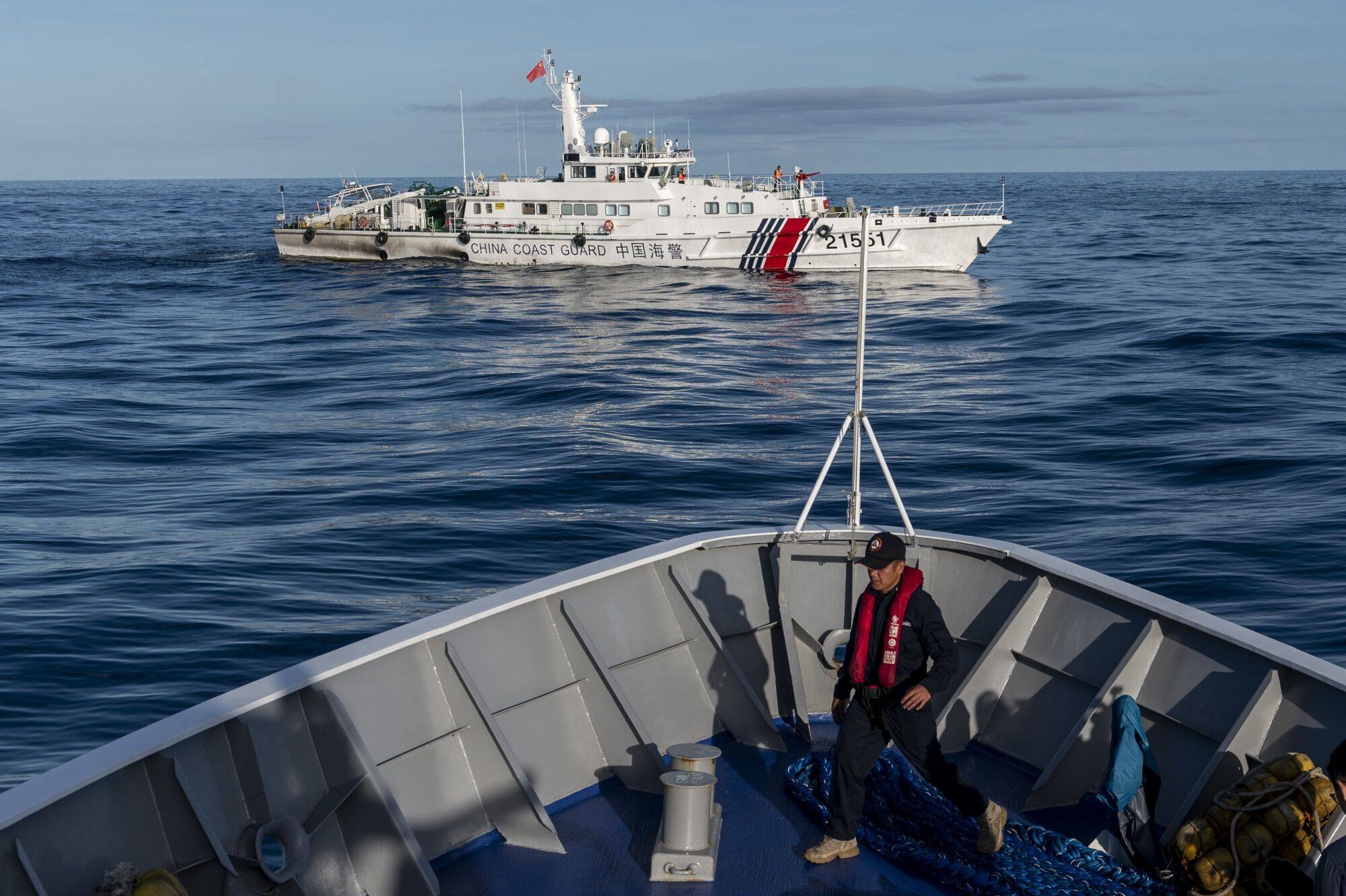 A China coastguard ship moves past a Philippine coastguard vessel BRP Sindangan, in the disputed Second Thomas Shoal, in the South China Sea. Photo: Bloomberg