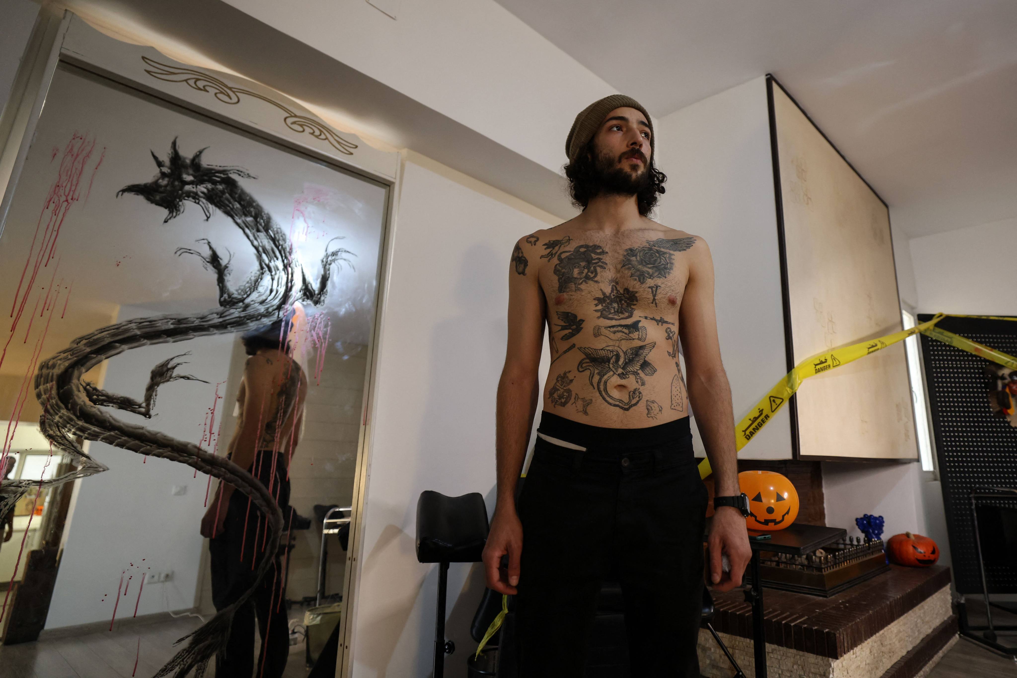 An Iranian man shows his tattoos in Iran’s capital, Tehran. Iranian tattoo artists have seen tattoos gain popularity in recent years, with some clients seeing them as a form of self-expression, others as an act of defiance against conservative Islam. Photo: AFP