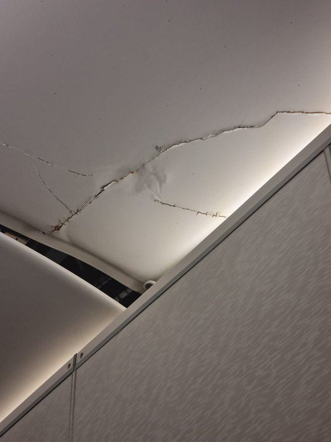 A social media user said they twice hit the Emirates flight’s ceiling, which was left cracked. Photo: X/MattRPD