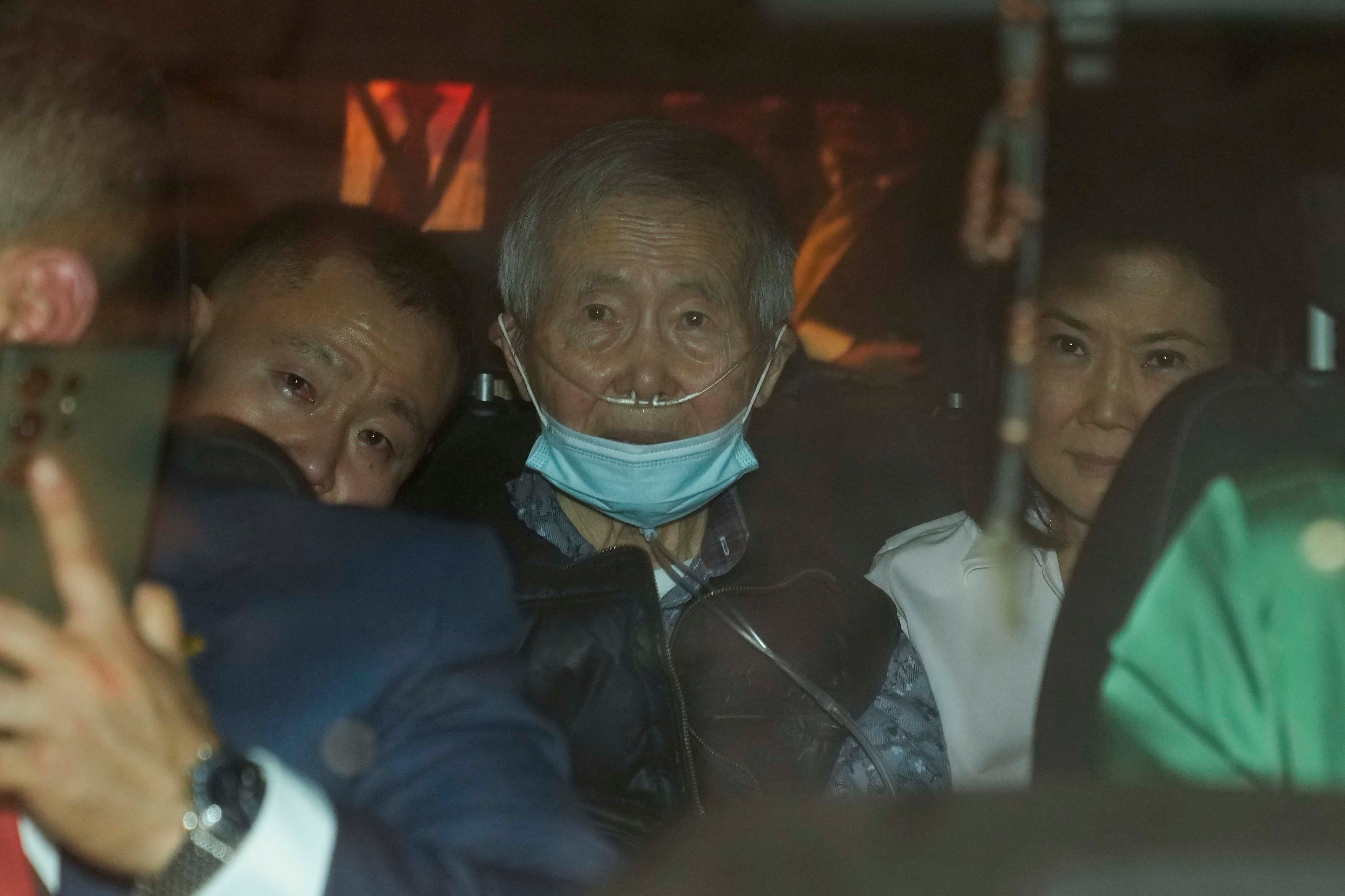 Peru’s former President Alberto Fujimori, 85, being driven out of prison by his children Keiko and Kenji. Photo: AP