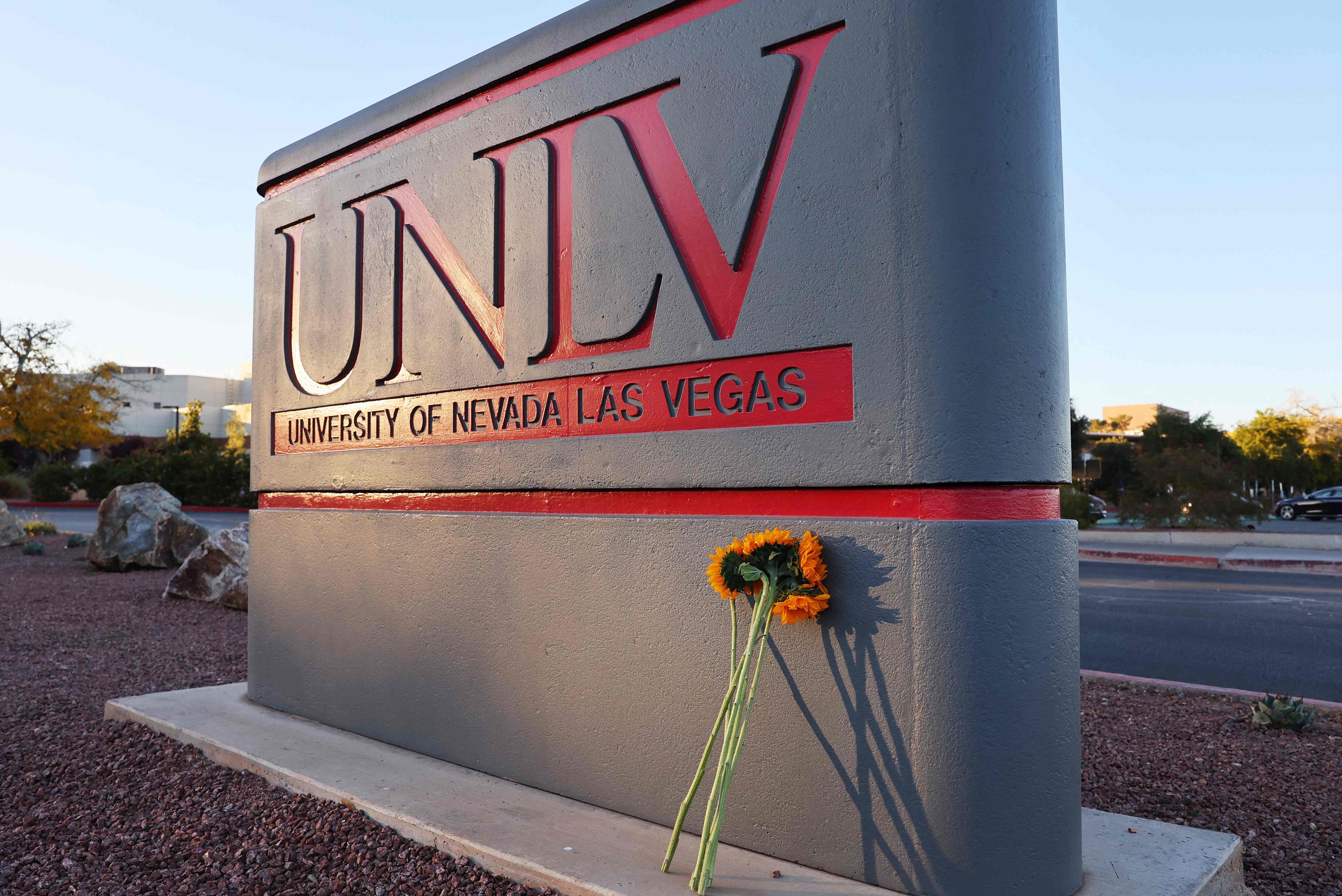 Flowers against a UNLV campus sign after a December 6 shooting left three dead. Photo: AFP