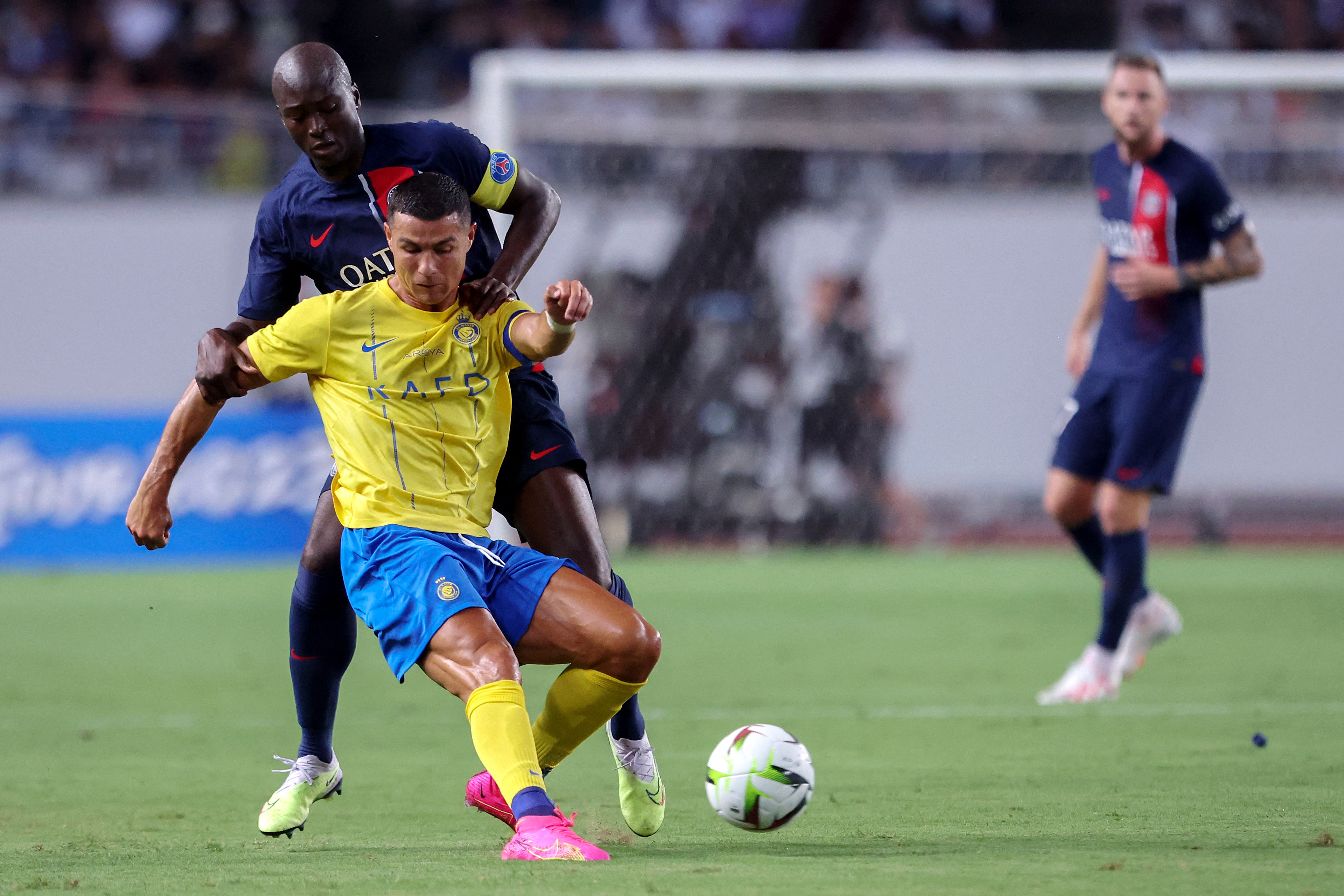 Paris Saint-Germain’s Danilo Pereira (back) fights for the ball with Al-Nassr’s Cristiano Ronaldo during a friendly at Nagai Stadium in Osaka on July 25. Photo: AFP 