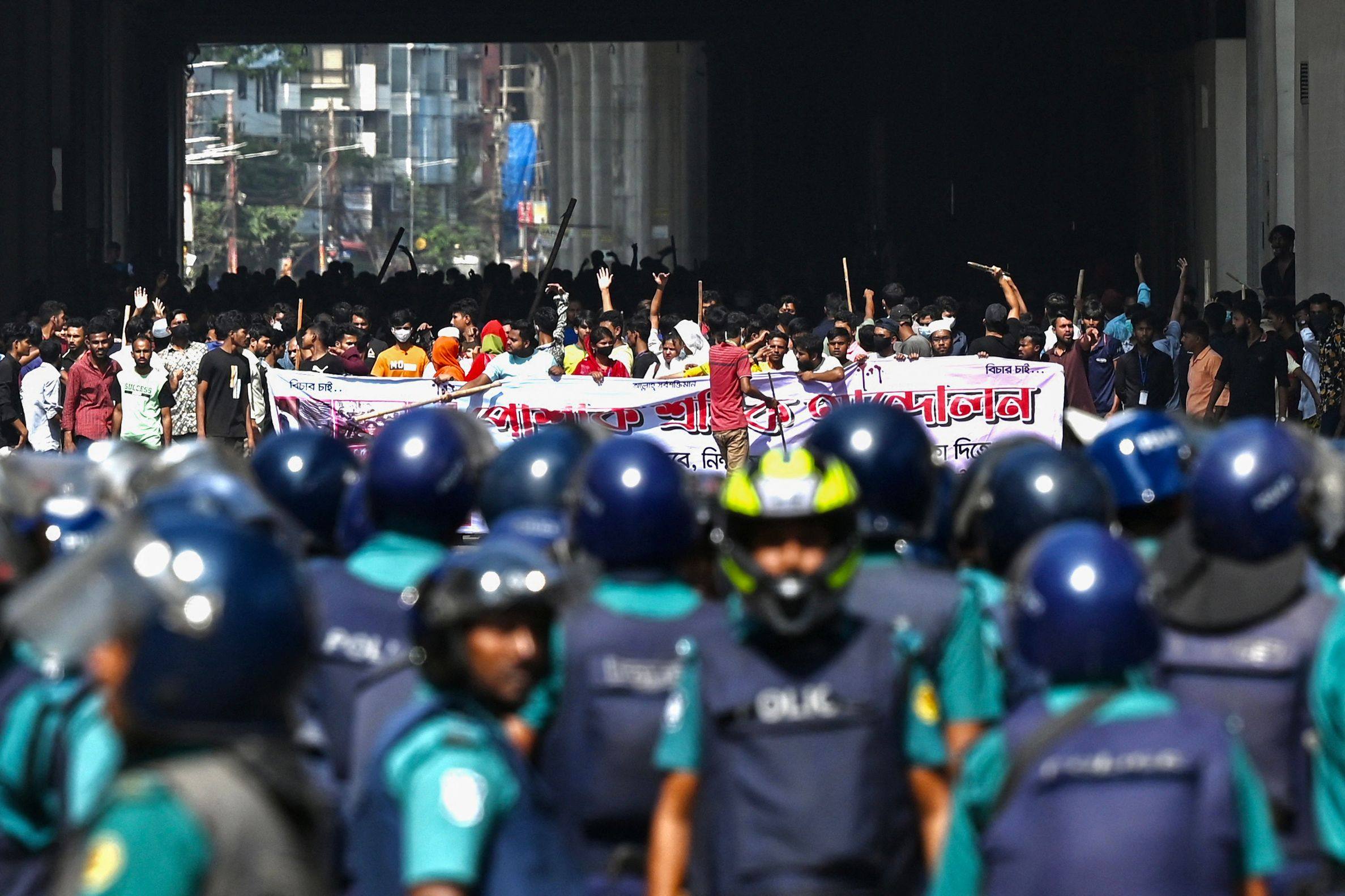 Bangladesh police stand guard as garment workers demand higher salaries in Dhaka on November 2. Photo: AFP