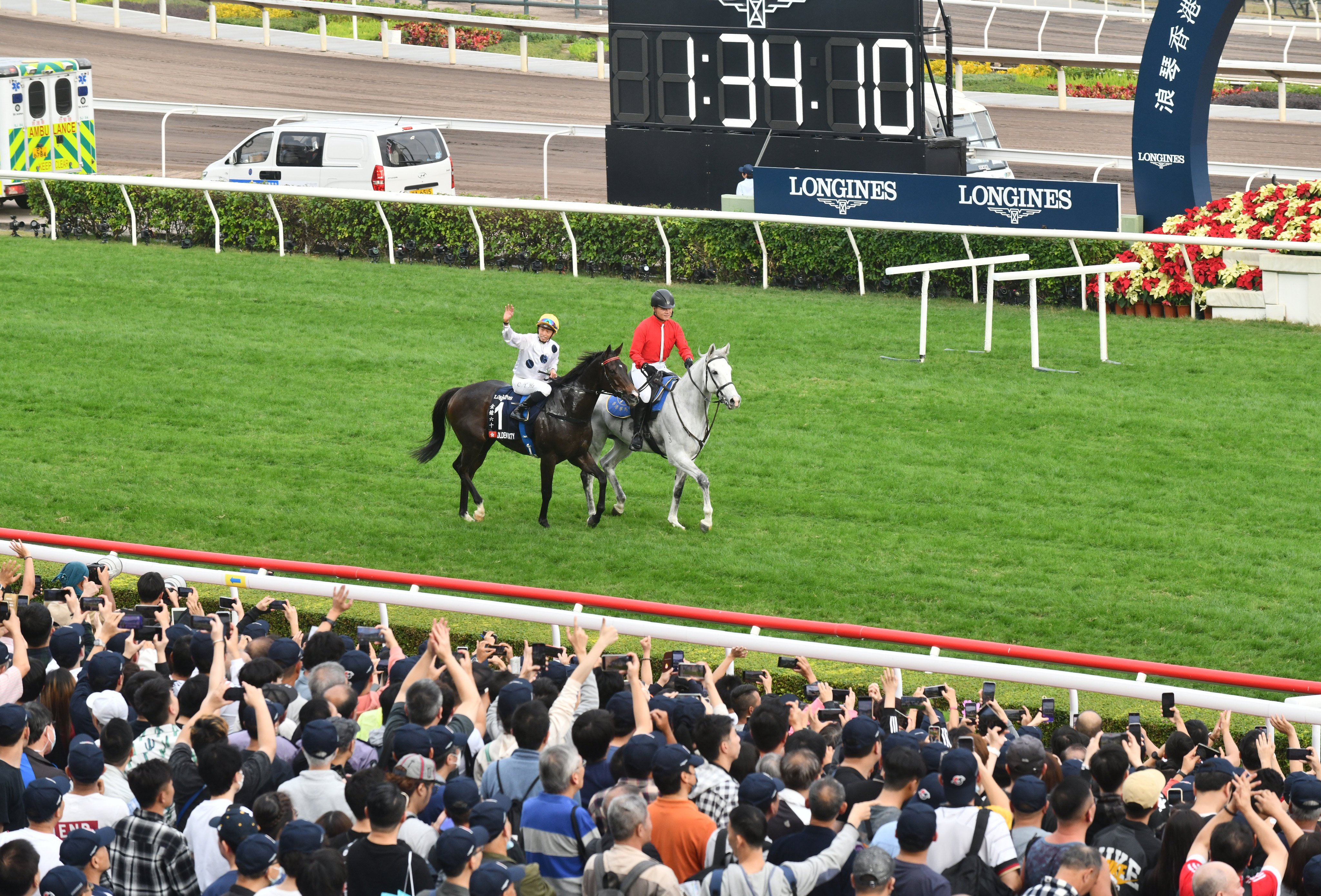 Vincent Ho waves to Golden Sixty’s adoring fans after the pair’s Hong Kong Mile win at Sha Tin on Sunday. Photos: Kenneth Chan