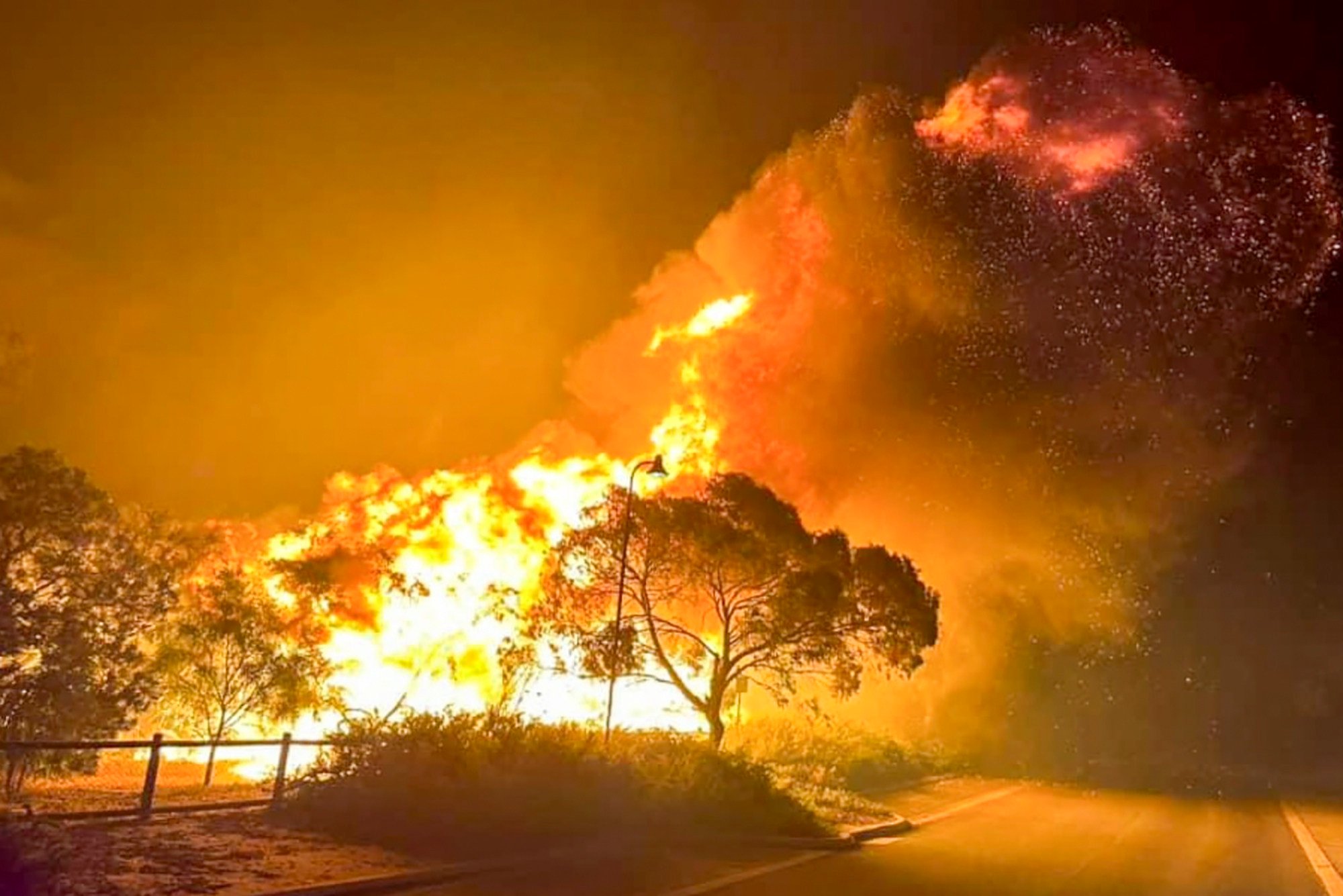 A fire rages in bushland near the Wannaroo, north of Perth, on November 23. Photo: DFES via AP 
