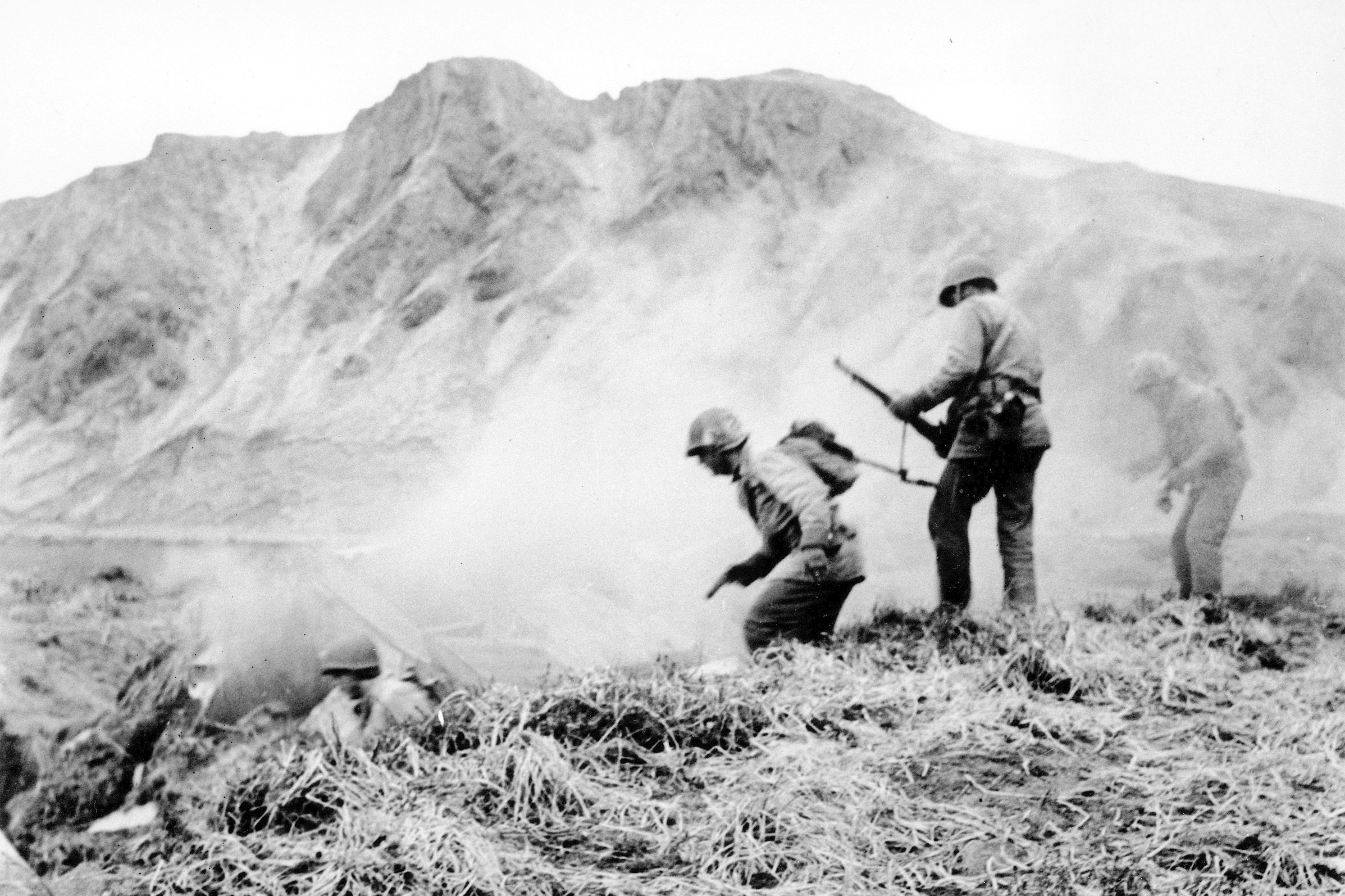 A US squad armed with guns and hand grenades closes in on Japanese holdouts entrenched in dugouts on Attu Island, Alaska, in June 1943 during World War II. Photo: US Army via AP