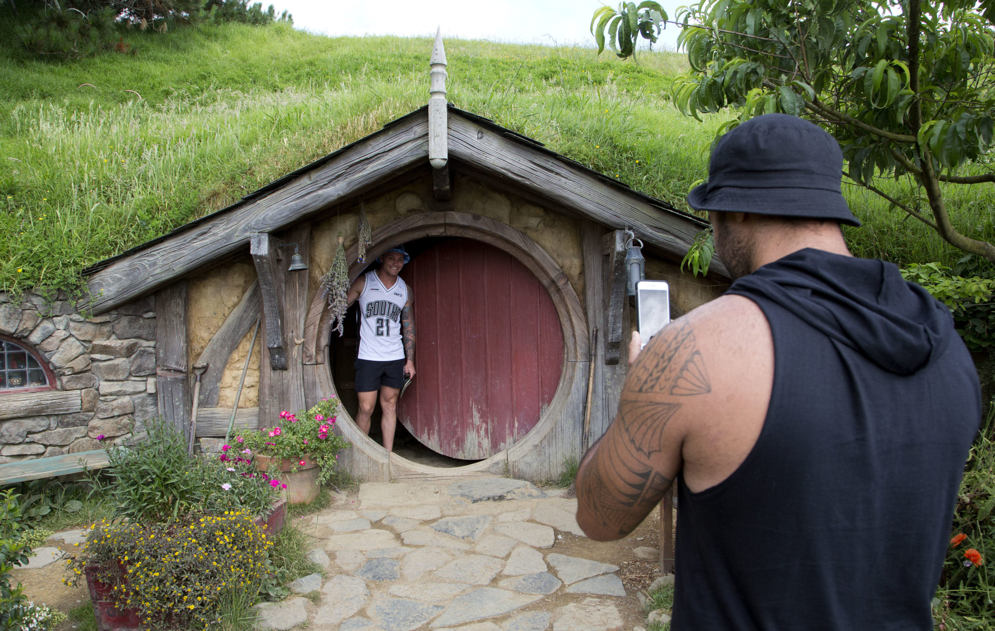 Tourists take photos during a tour of “The Hobbit” film set near Matamata, New Zealand, in 2015. Photo: AP