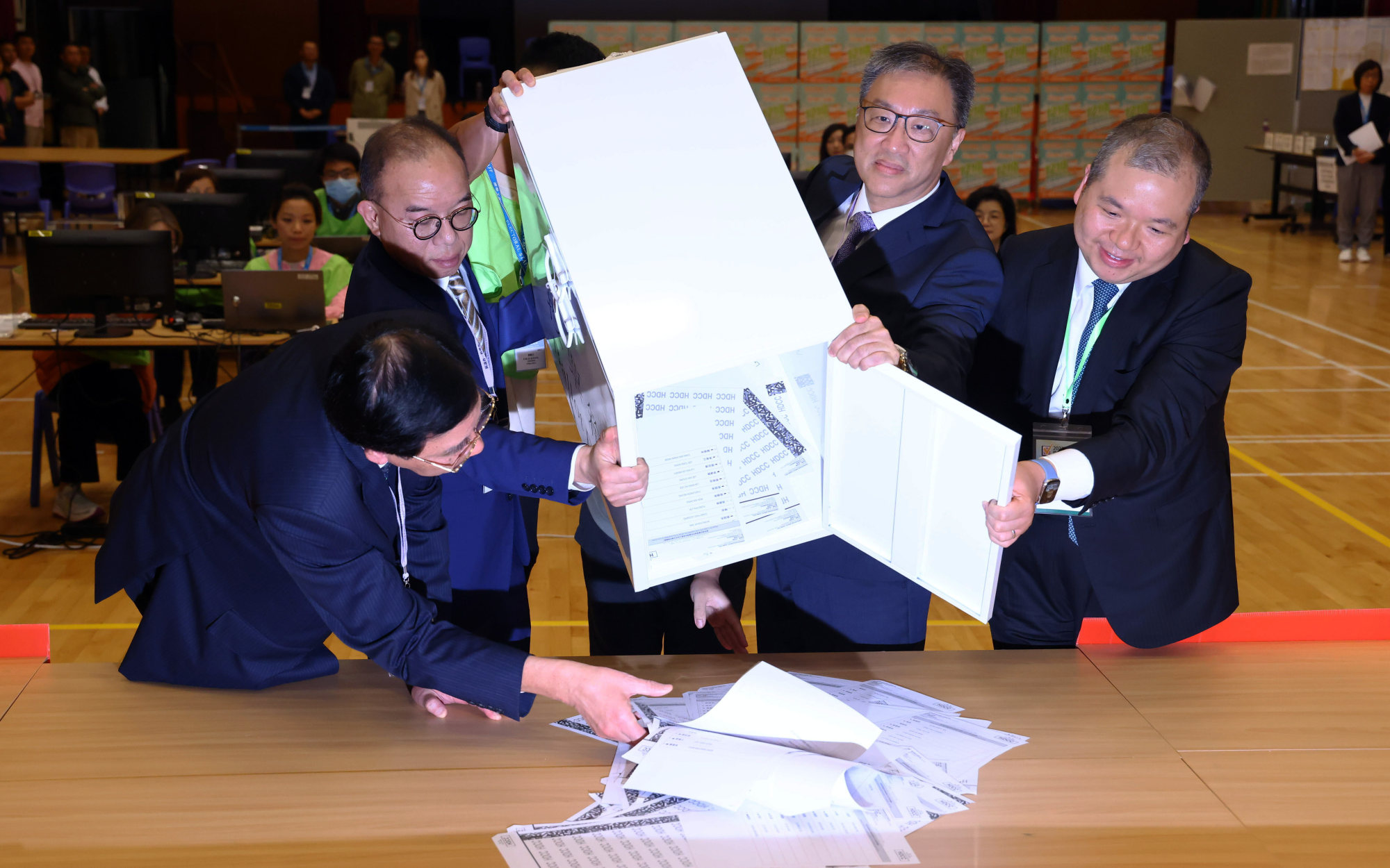 (From left) Electoral Affairs Commission member Daniel Shek, constitutional affairs chief Erick Tsang, commission head Mr Justice David Lok and Senior Counsel Bernard Man empty a ballot box in San Po Kong. Photo: Dickson Lee