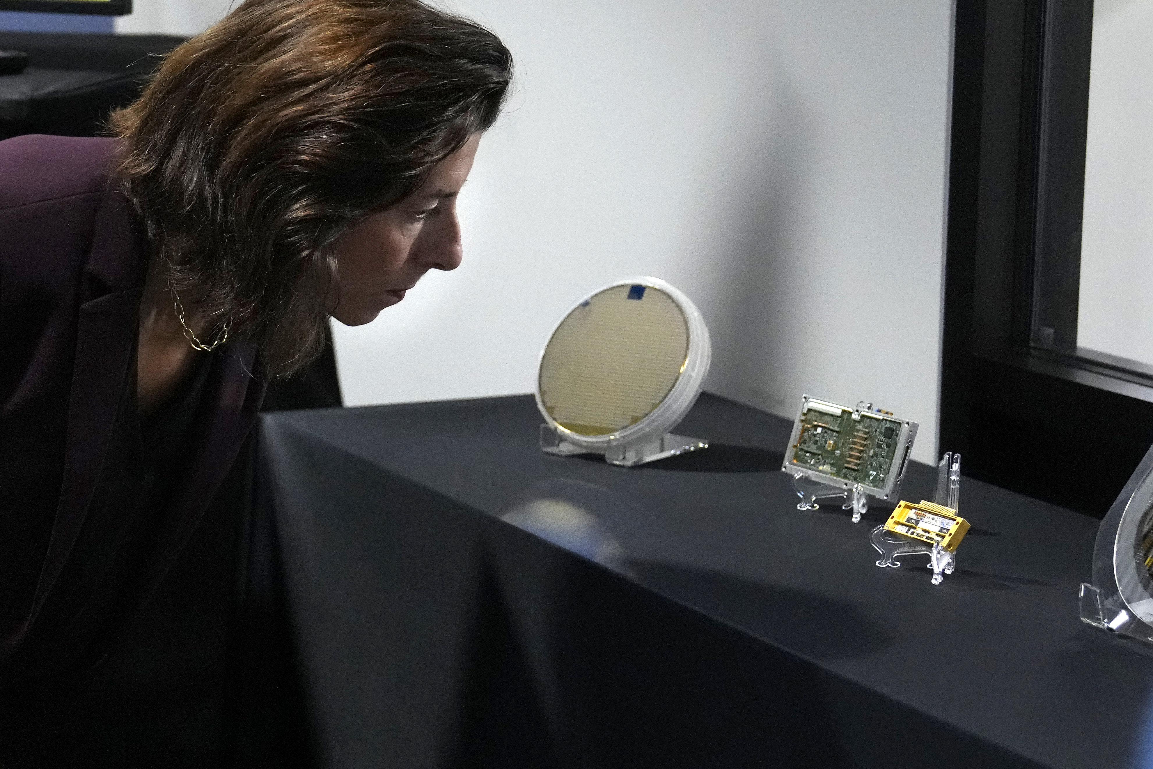 US Commerce Secretary Gina Raimondo looked at semiconductor products during a visit to a BAE Systems facility in Nashua, New Hampshire, on Monday. Photo: AP Photo