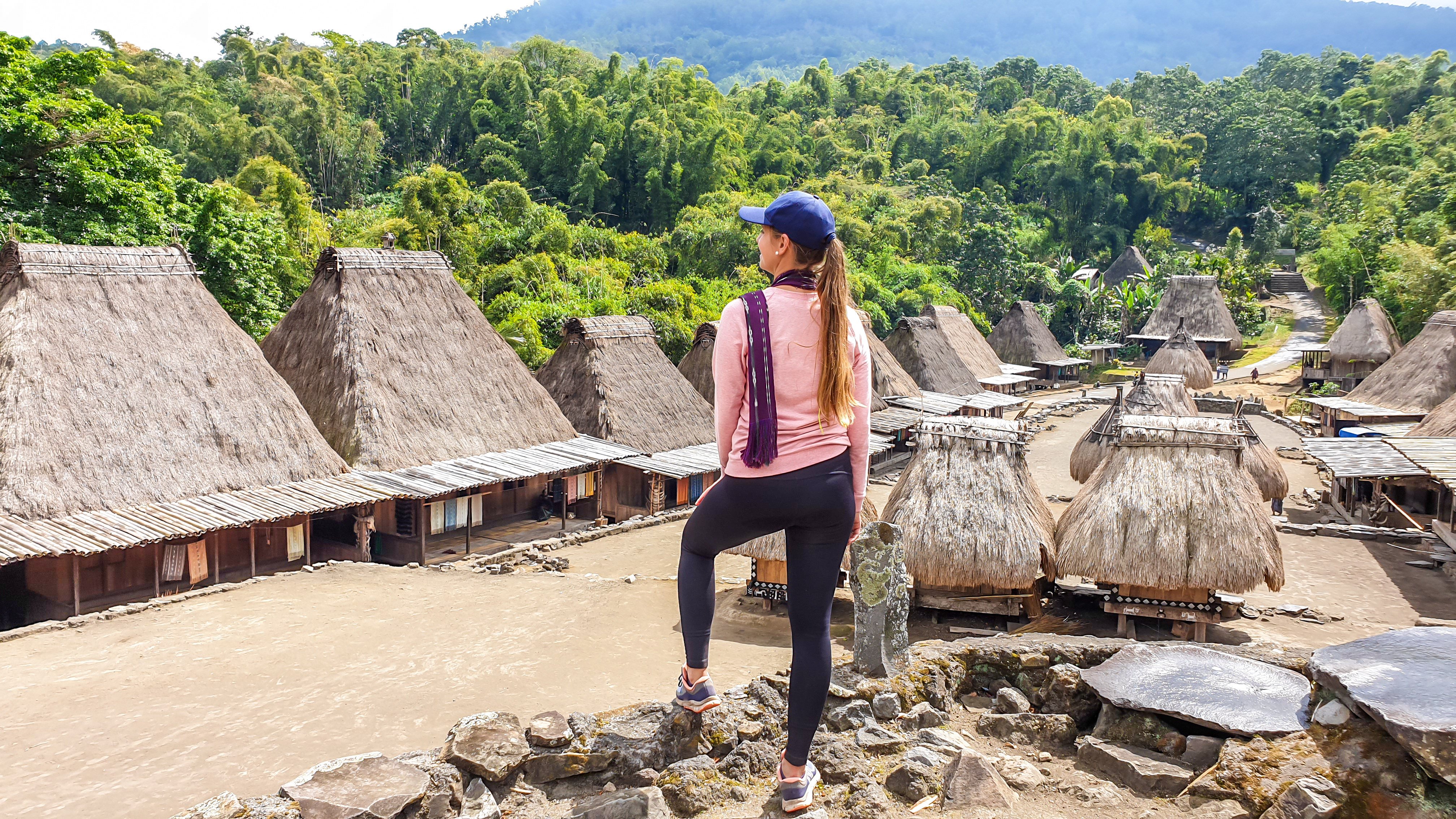 A young woman takes in the view in Beno village in Flores, Indonesia. Young travellers are more likely to prioritise photography and smaller accommodation on their holidays than their older counterparts. Photo: Getty Images