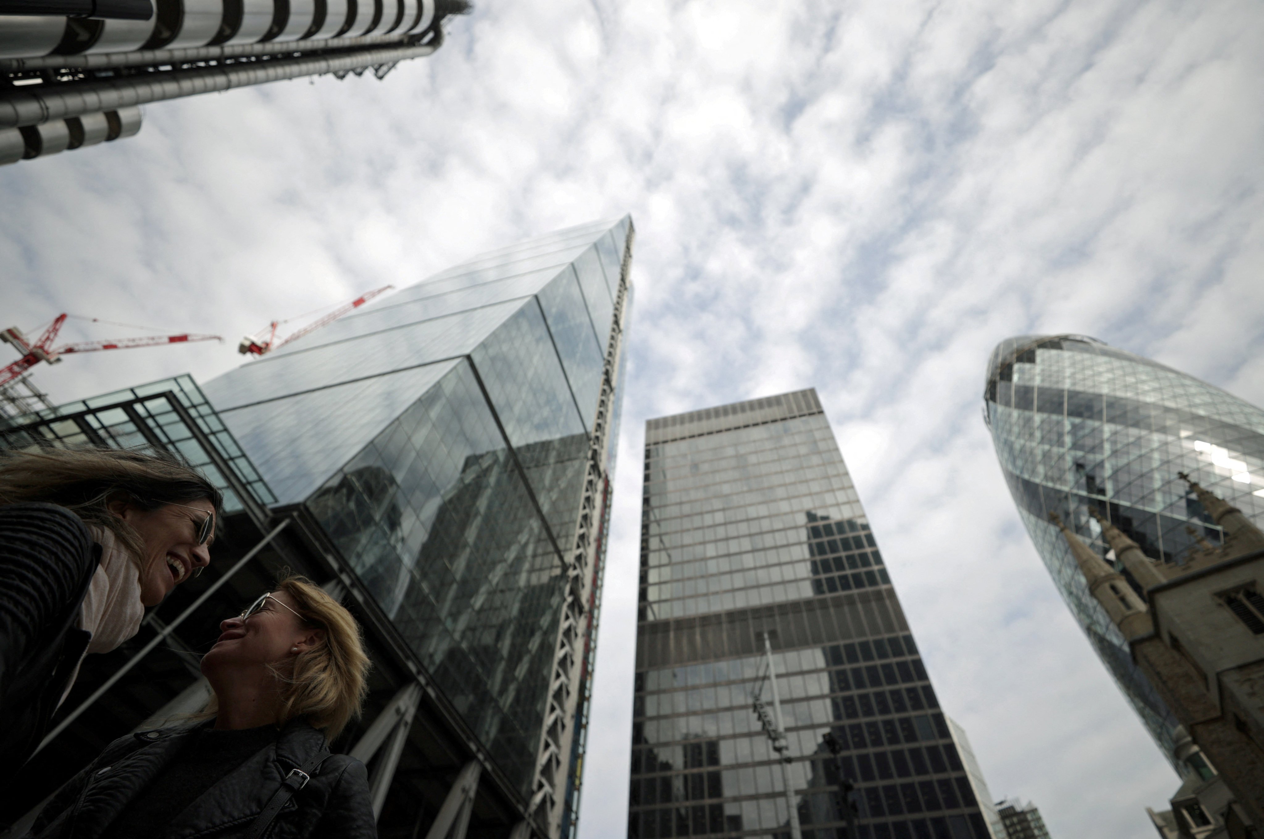 People walk through the City of London financial district in London, Britain. Photo: Reuters