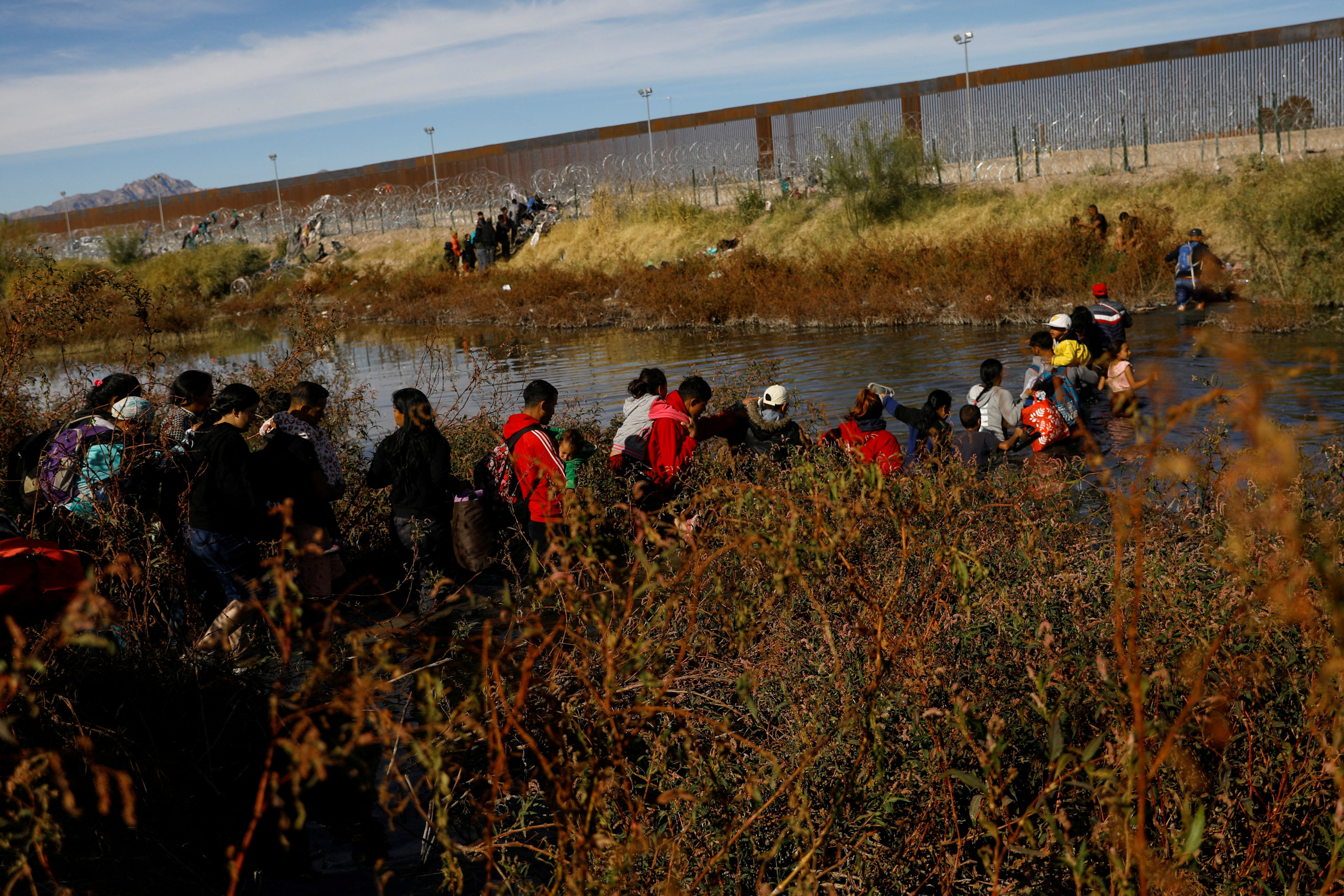 Migrants seeking asylum in the United States cross the Rio Bravo River, the border between the US and Mexico, as seen from Ciudad Juarez, Mexico, on December 5. Photo: Reuters
