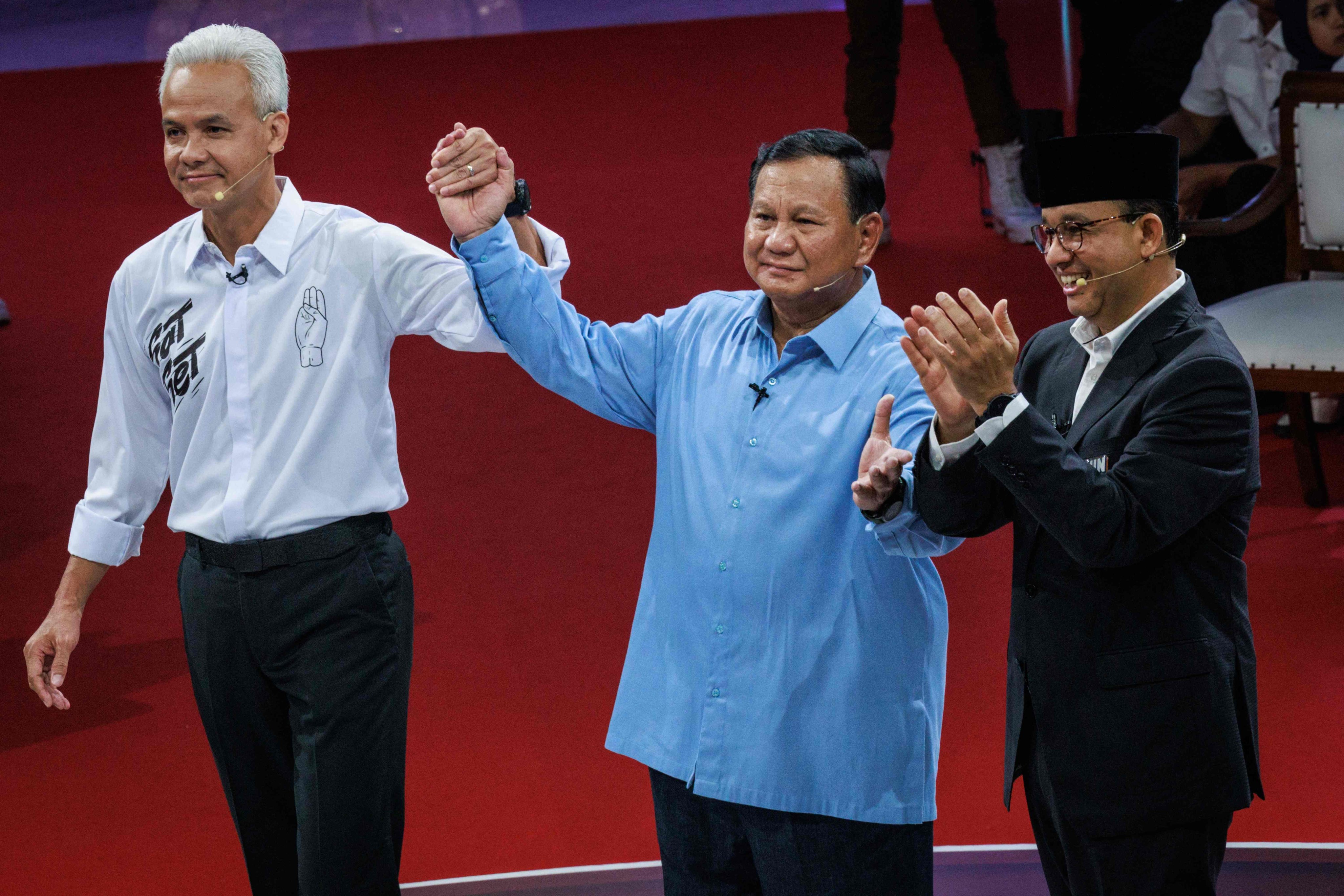 Ganjar Pranowo, Prabowo Subianto and Anies Baswedan pose after the first presidential election debate on December 12. Photo: AFP 