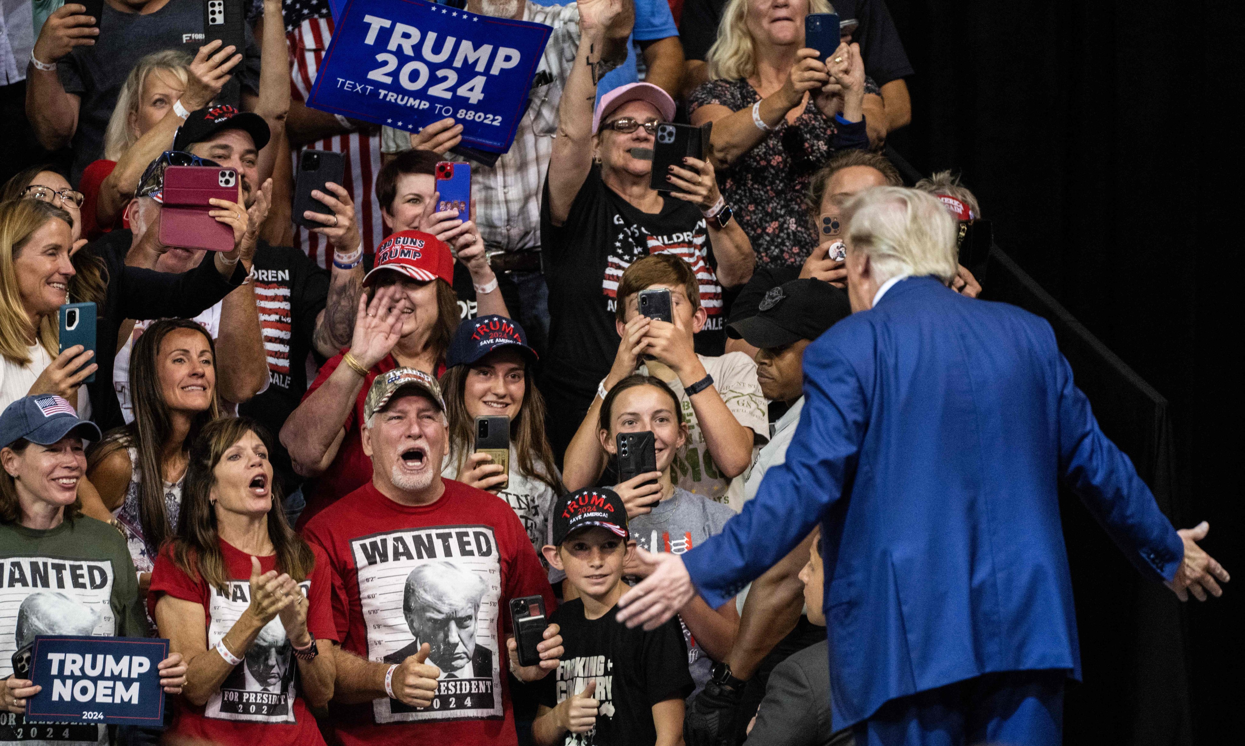 Former US president and 2024 Republican presidential hopeful Donald Trump gestures as he leaves the stage after speaking during a rally in Rapid City, South Dakota, on September 8. Photo: AFP