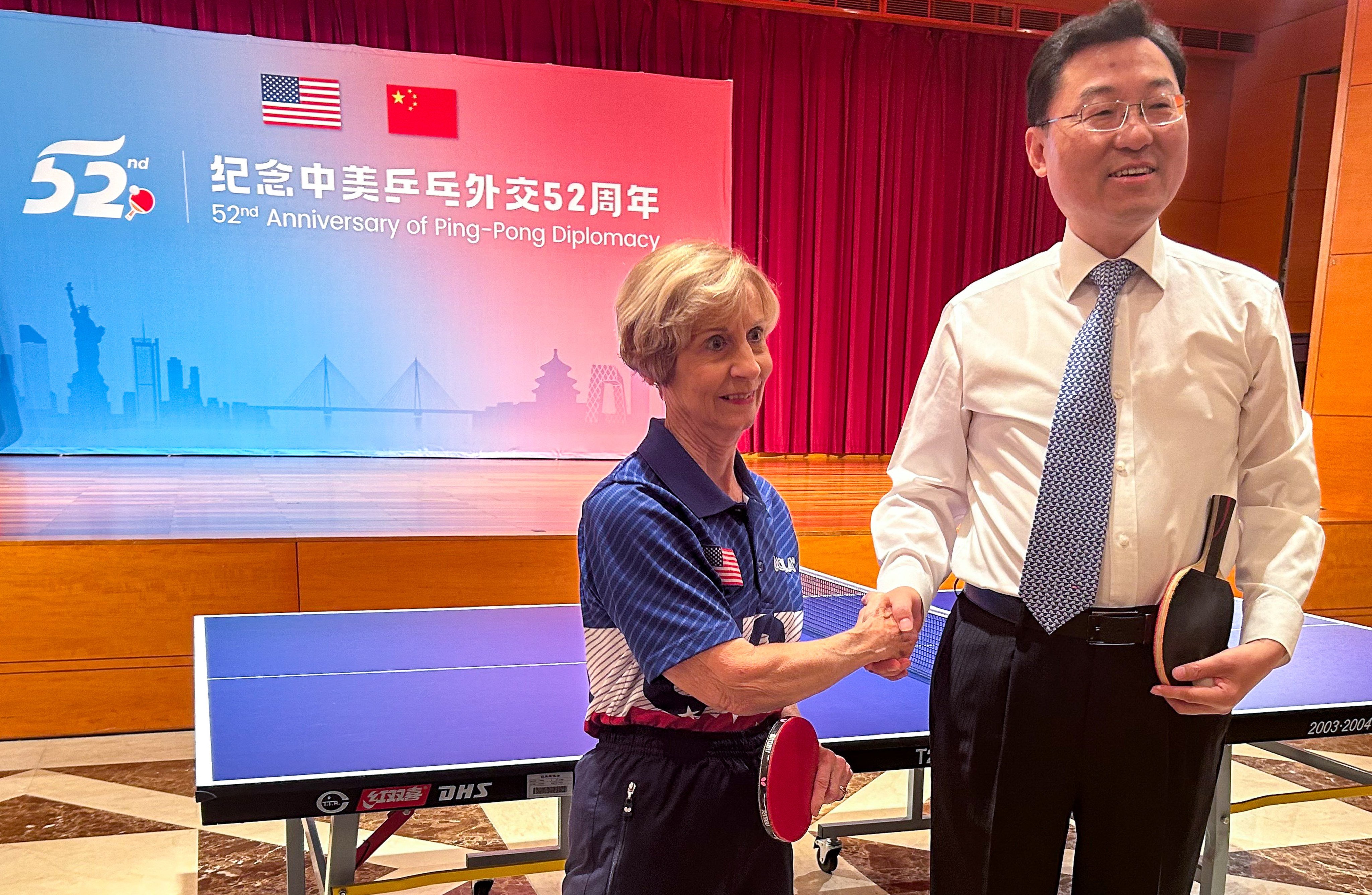 Chinese ambassador to Washington Xie Feng (right) shakes hands with American table tennis player Connie Sweeris following a friendly match at an event celebrating 52 years of “ping pong diplomacy” in Washington on Wednesday. Photo: Khushboo Razdan