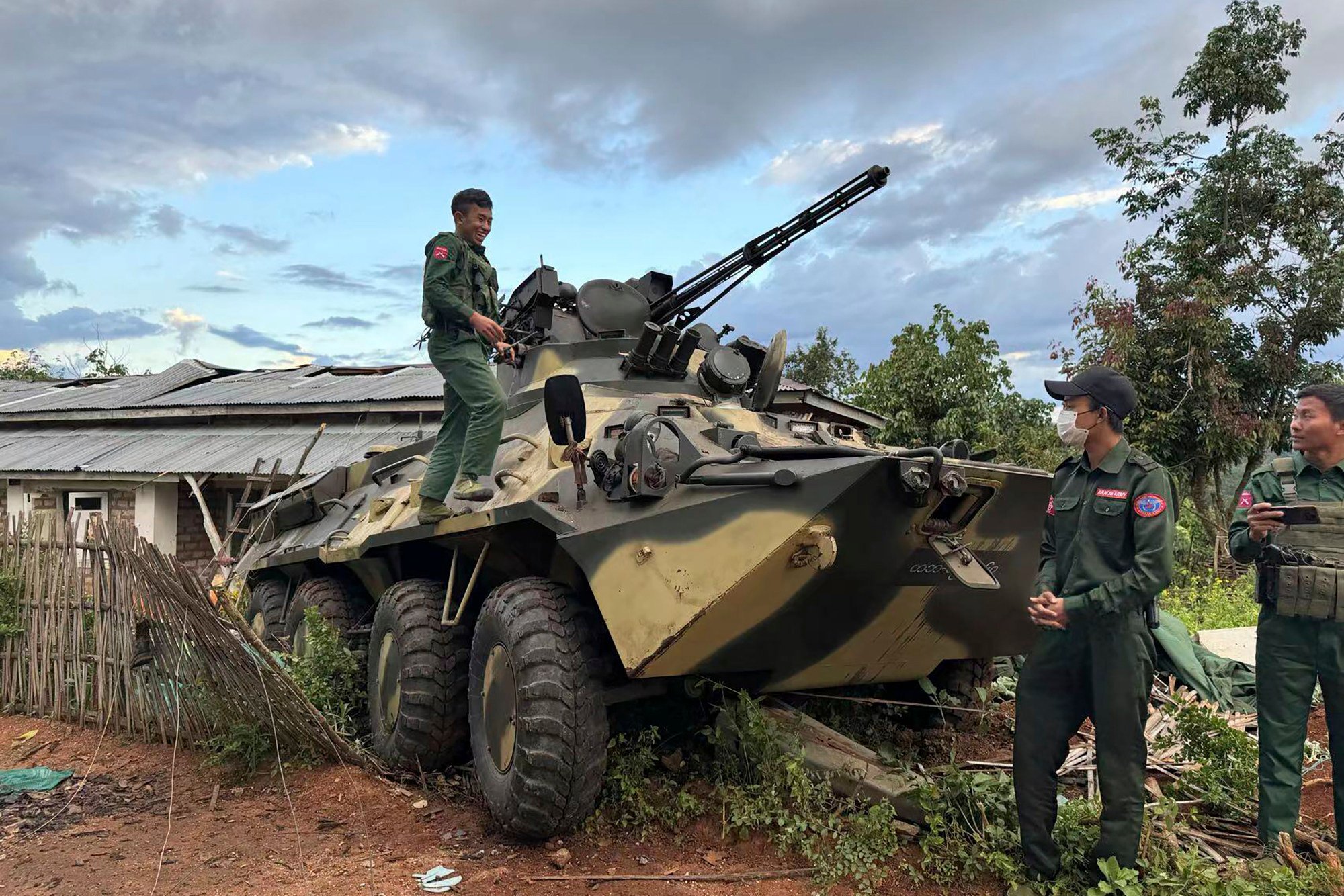 Members of an ethnic armed forces group, one of the three militias known as the Three Brotherhood Alliance, check an army armoured vehicle the group allegedly seized from Myanmar’s army outpost on a hill in Hsenwi township in Shan state last month. Photo: The Kokang online media via AP