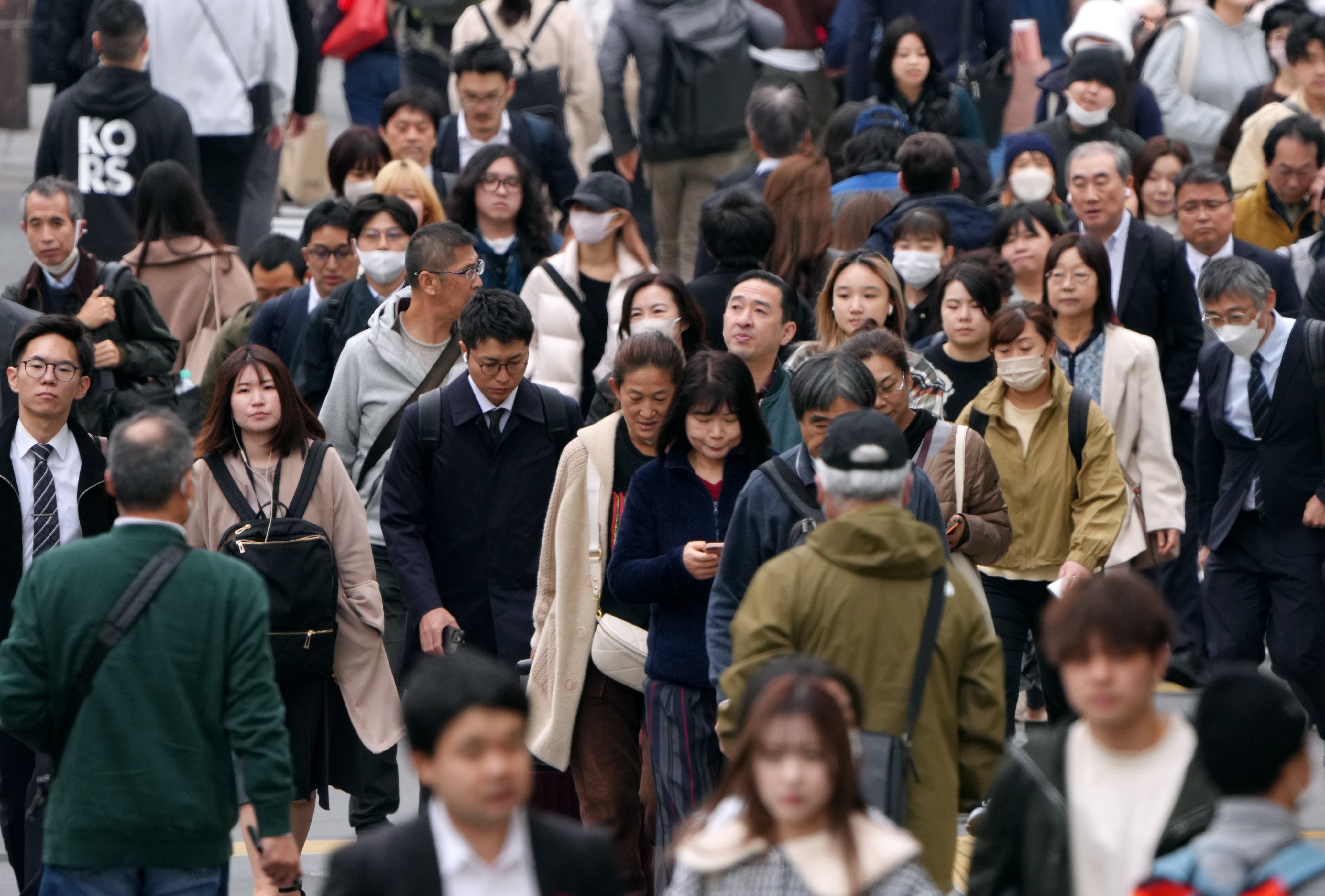 Pedestrians commute on Shinjuku street in Tokyo. Japan would need 6.7 million foreign workers by 2040 to meet its own projected economic growth rates, a 2022 report showed. Photo: EPA-EFE