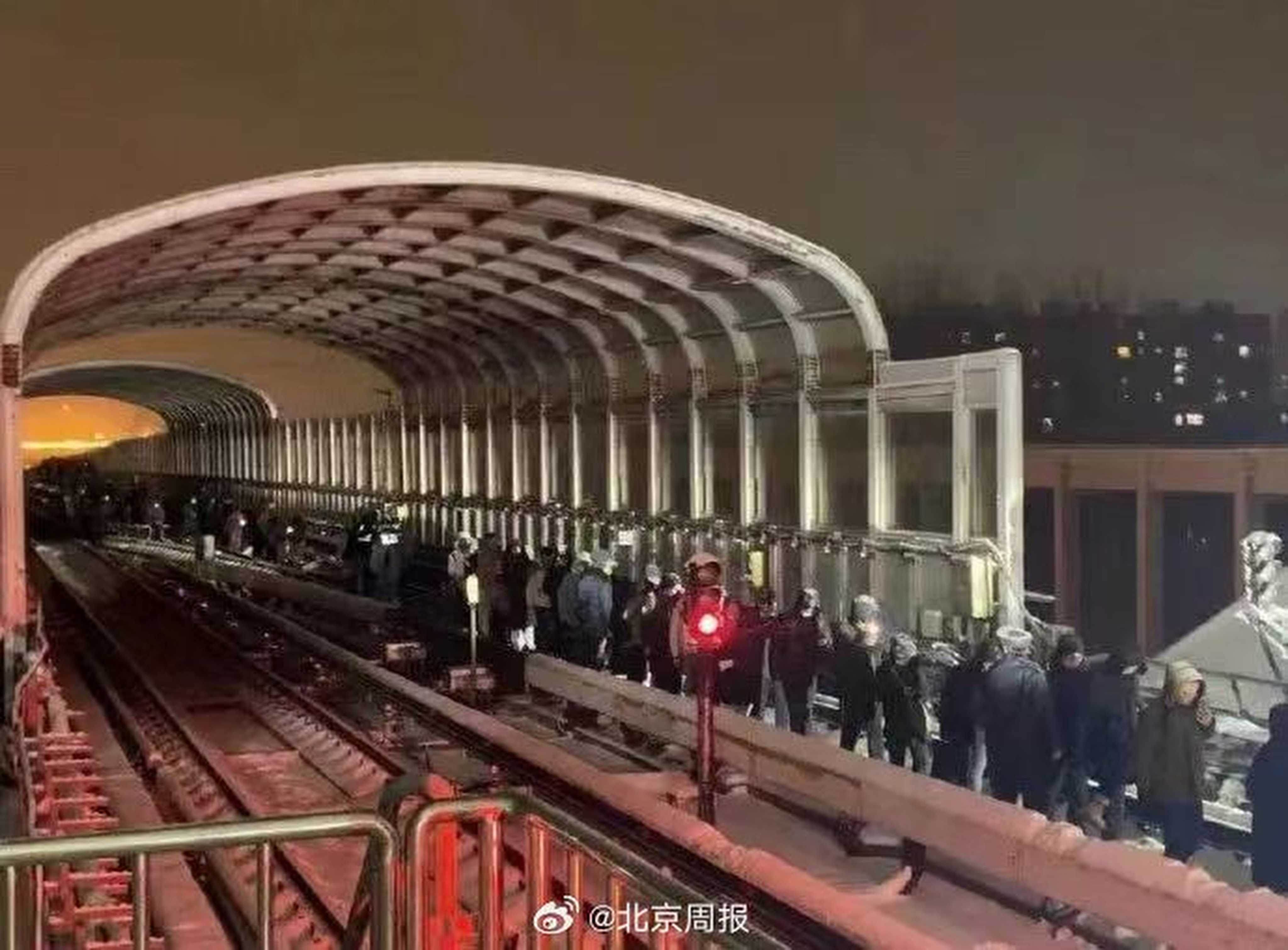 Passengers leave the stricken carriages with the help of Beijing Subway staff after an incident on the Changping line injured more than 100 people during severe snowstorms in northern China. Photo: Weibo