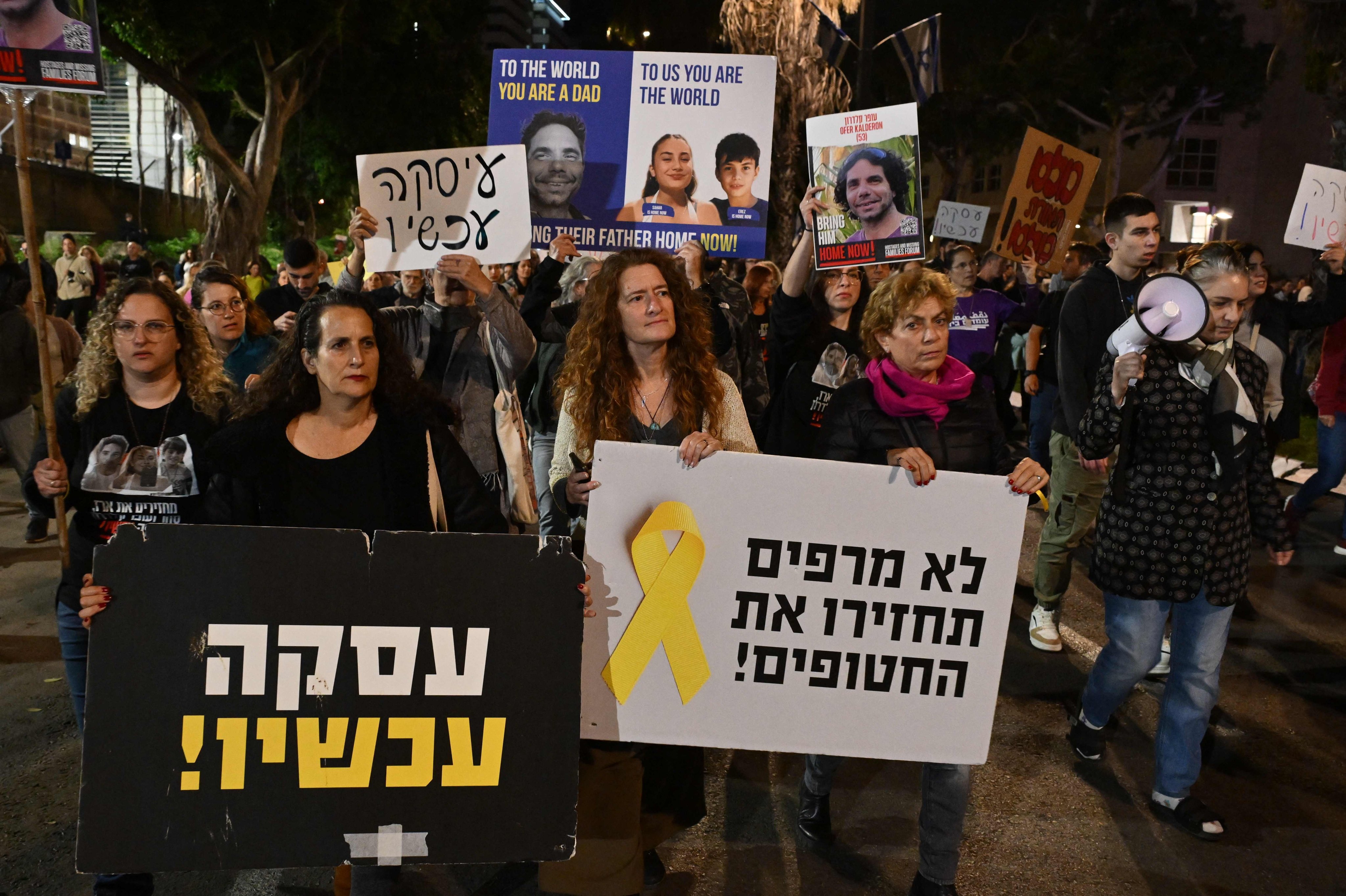 Friends and relatives of Israeli hostages held in Gaza lift placards during a demonstration in Tel Aviv on Saturday. Photo: AFP