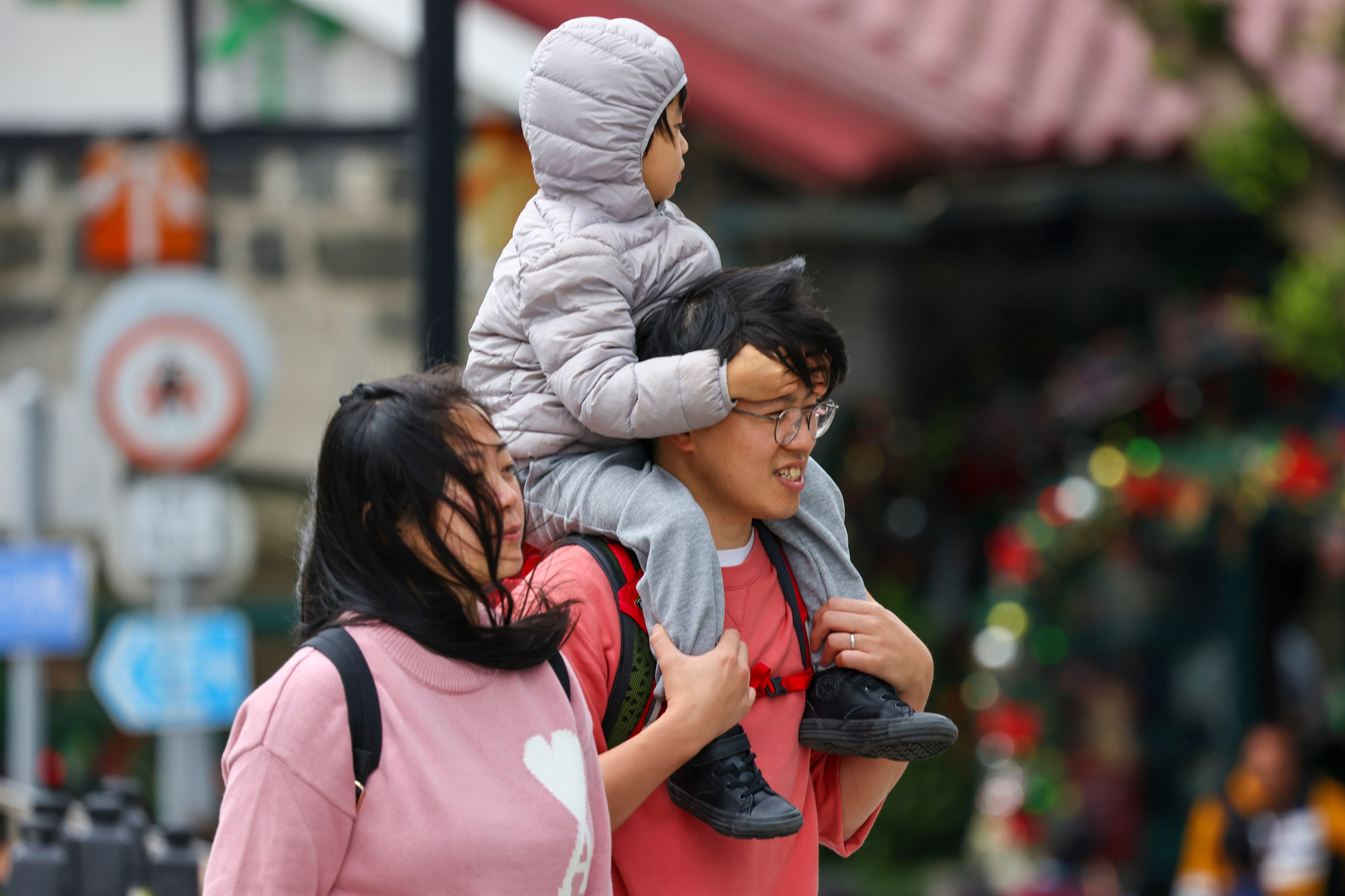 Parents walk with their child at The Peak on December 16. Efforts to make Hong Kong a more family-friendly city have been hampered by resistance to flexible working from employers, budgetary concerns and more. Photo: Dickson Lee