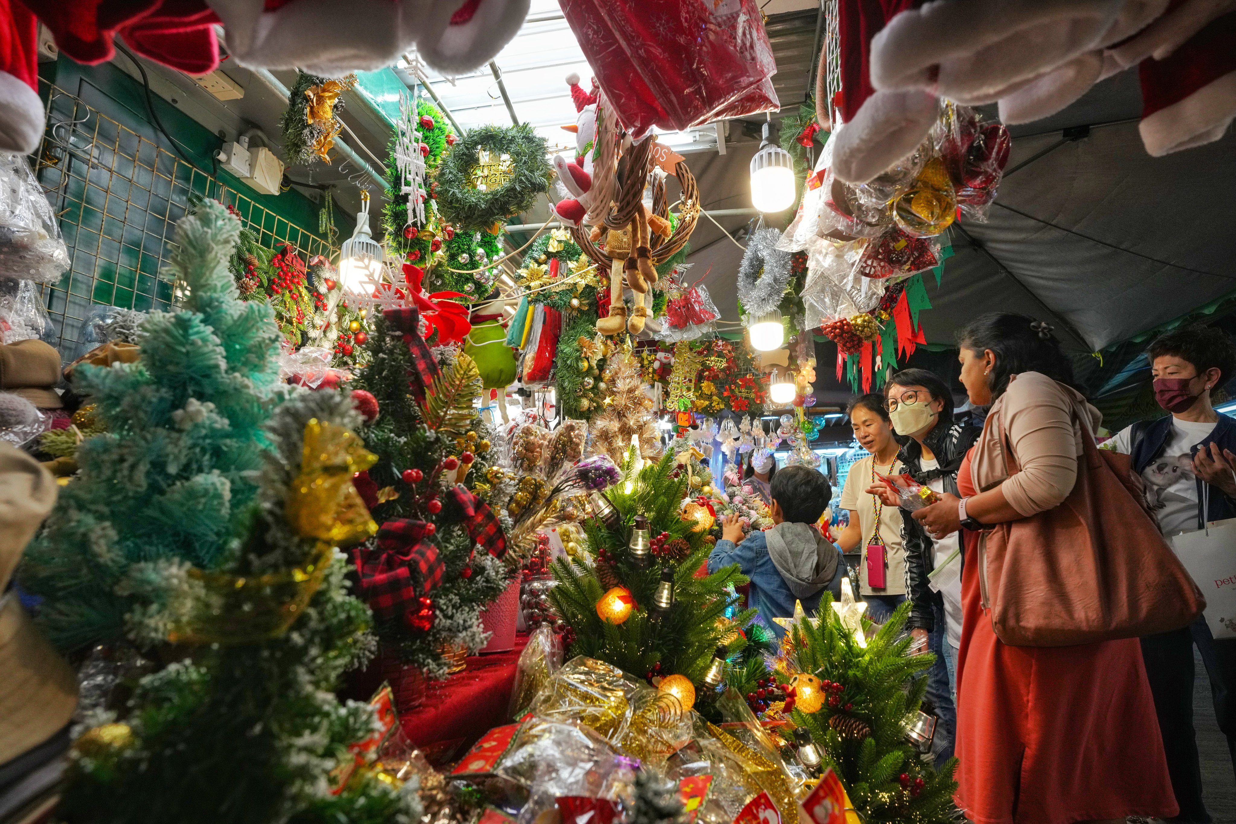 Shoppers browse for Christmas products at the stalls on Tai Yuen Street in Wan Chai. Photo: Elson LI