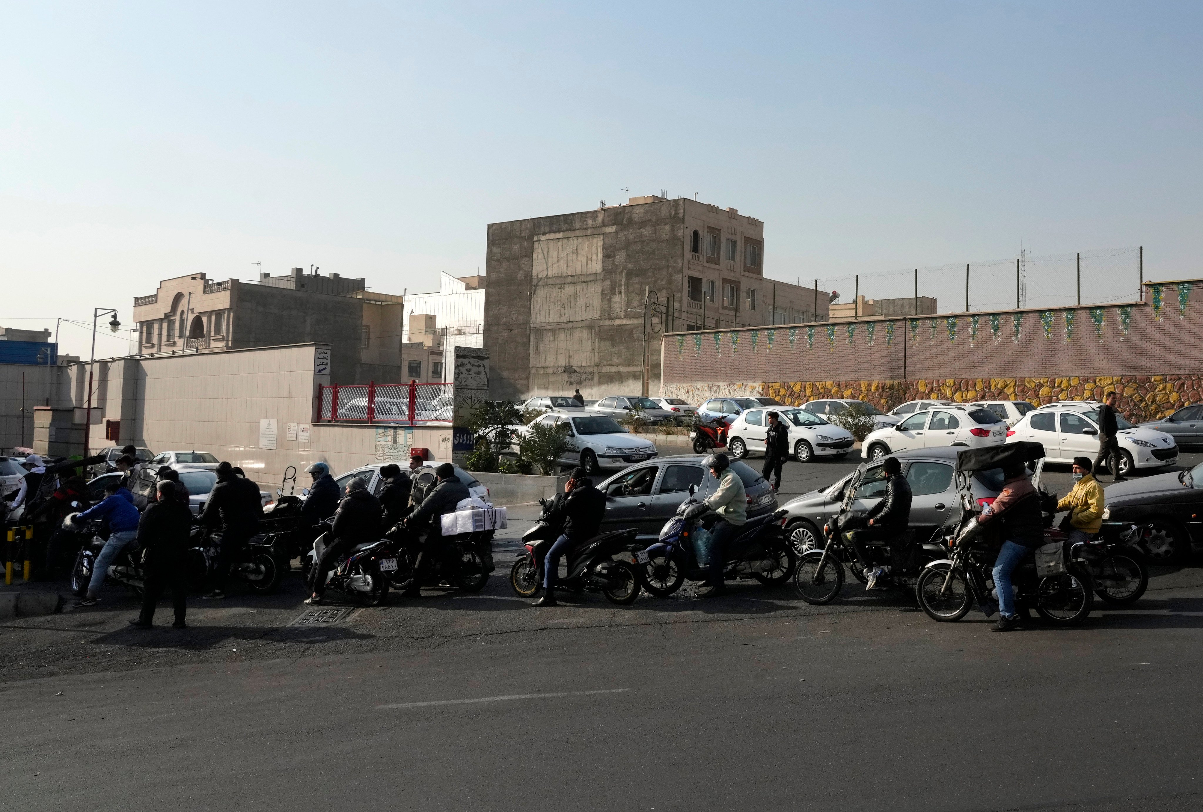 Motorcycles and cars queue up outside a petrol station in Tehran, Iran on Monday. Photo: AP